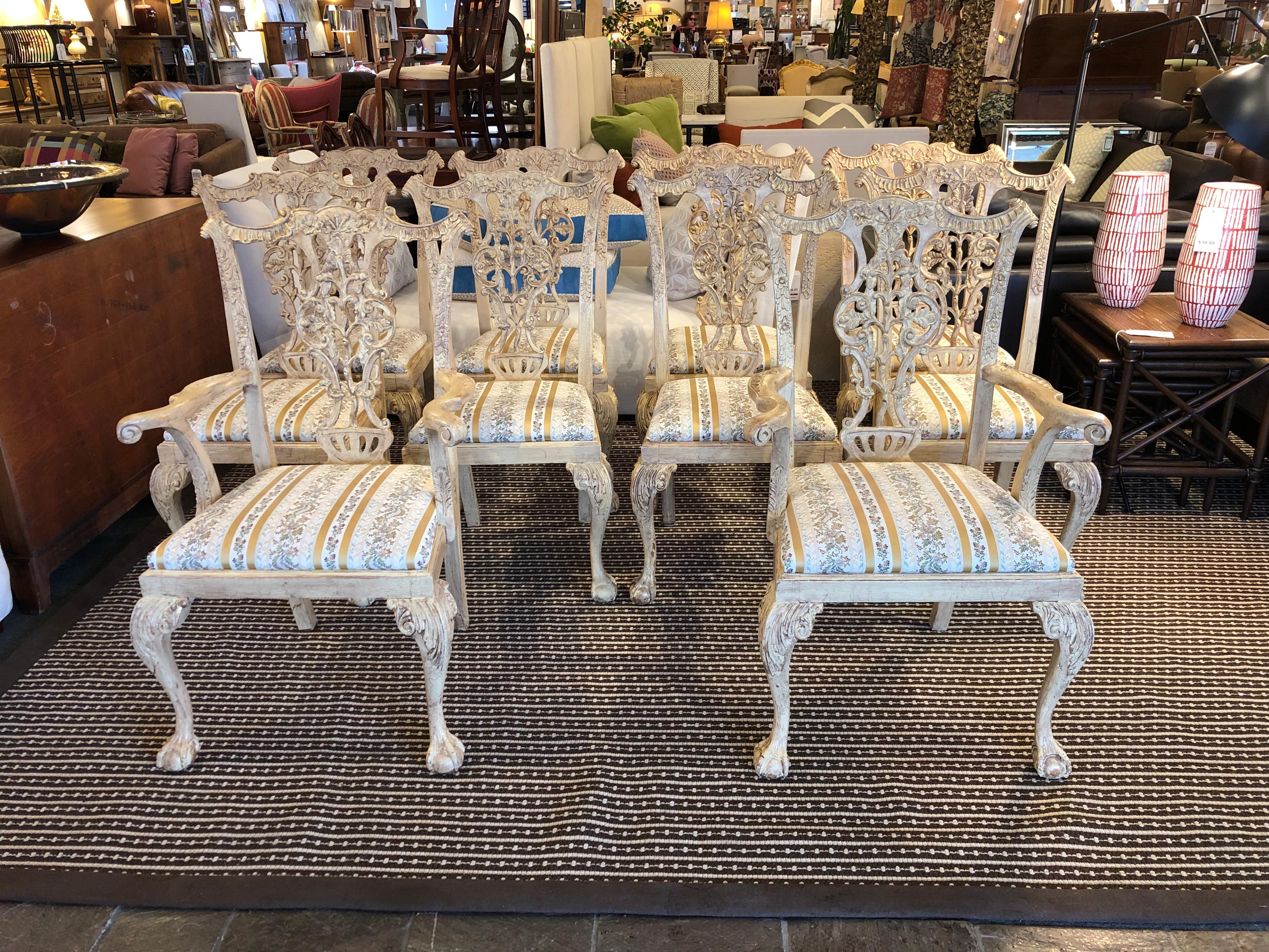 Custom set of 10 Chippendale dining chairs. With the two armchairs, each piece has a multilayer ivory antiqued finish with a crackle effect. Just one more beautiful embellishment to the craved and jacquard upholstered set. Custom elegance from San