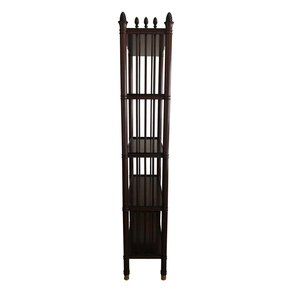 -Sold as a set of 2.
-A pair of mahogany four-tier étagères.
-Slender ring turned columns joining open work sides and four mahogany shelves with ebonized molding.
-The columns embellished with ebonized acorn finial and brass cap feet.
-From a