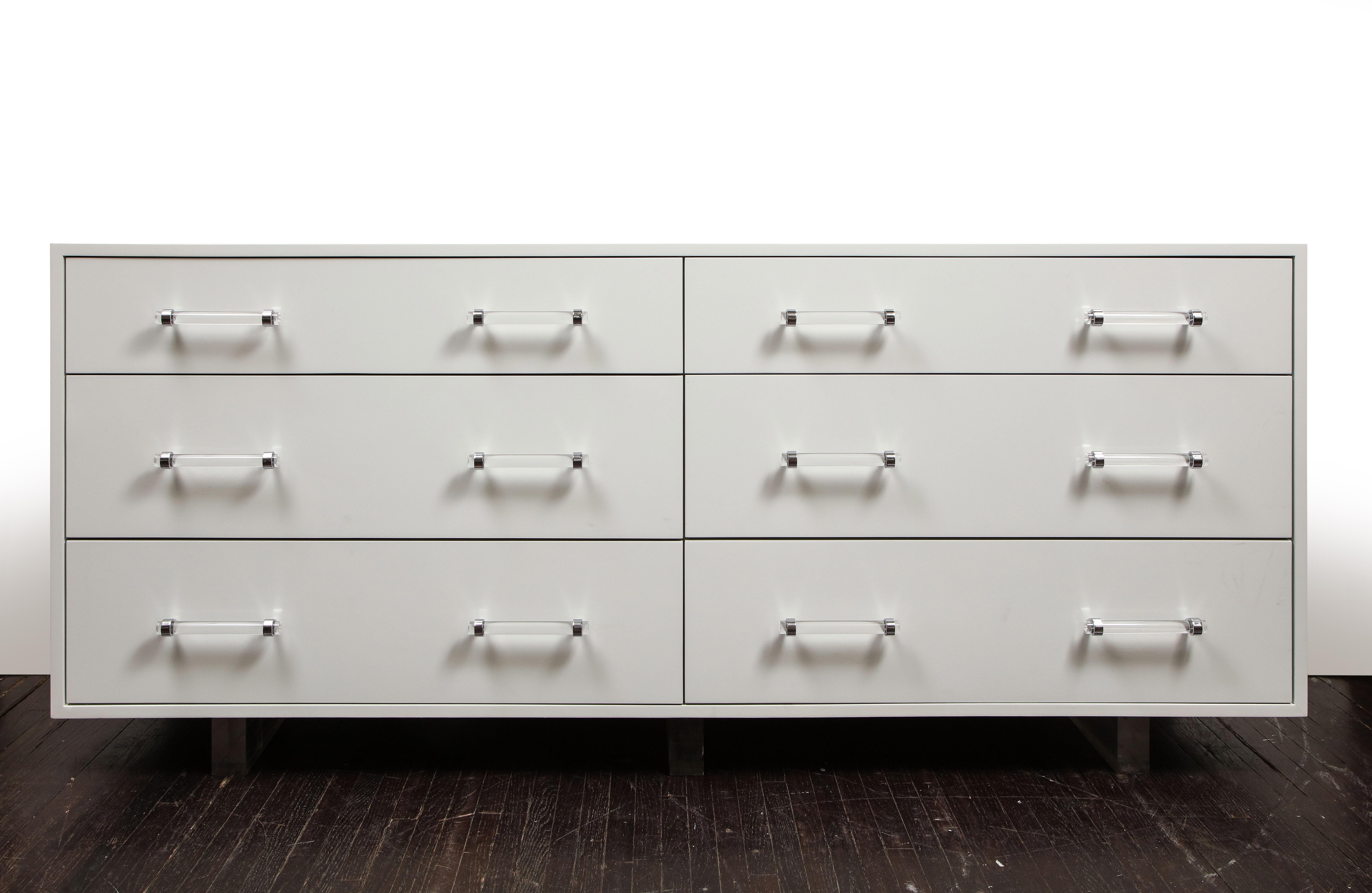 Made to order lacquered 6-drawer dresser on recessed acrylic legs. Shown in white violet color in high gloss finish and acrylic handles in chrome finish. The inside of drawers were finished in the same color as exterior in satin finish. Orders are