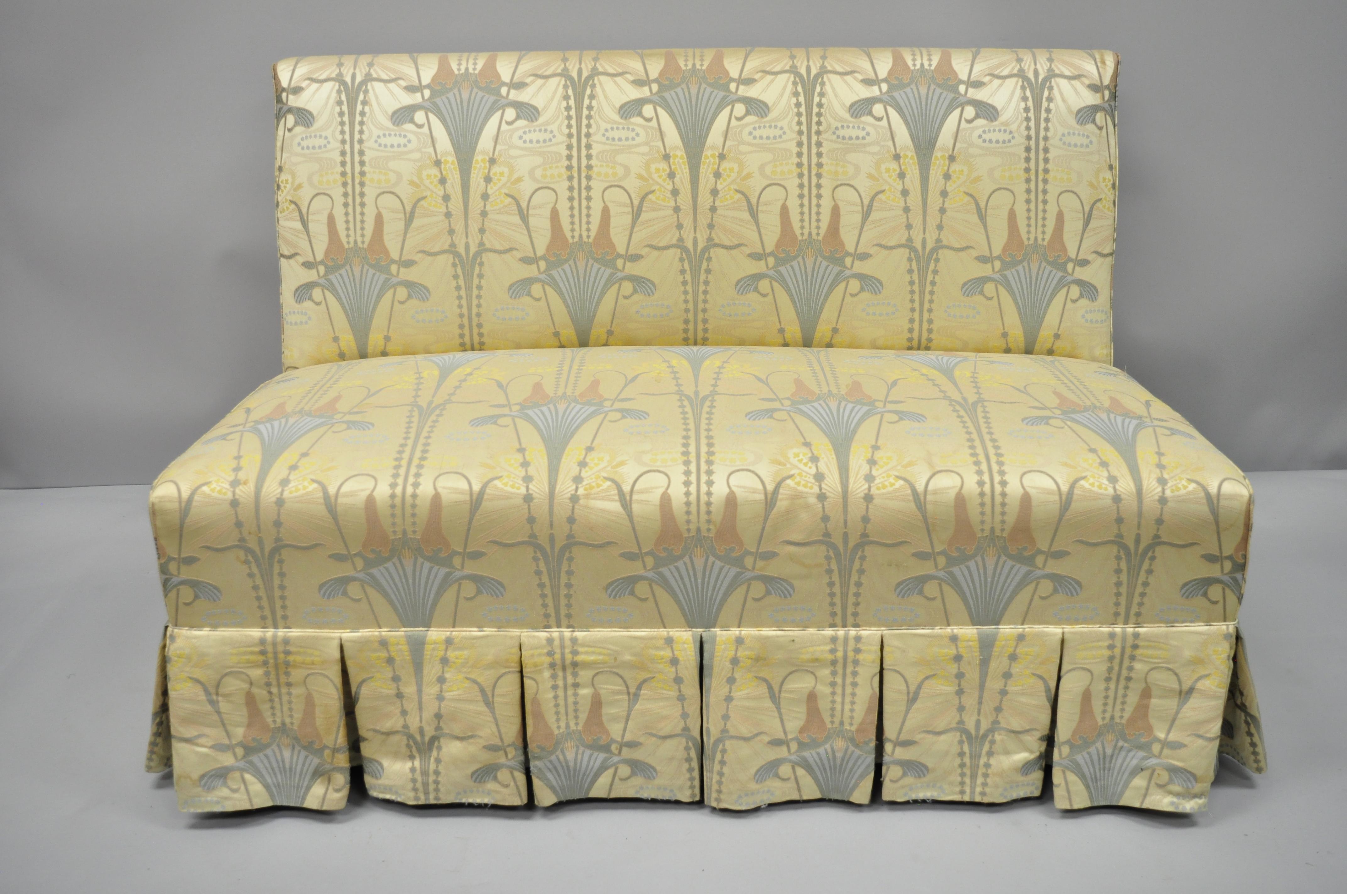 Custom floral Art Nouveau fabric gold blue slipper chair armless loveseat. Item features fully upholstered with skirt, beautiful Art Nouveau inspired floral printed pink, gold, and blue fabric, heavy solid wood frame, quality American craftsmanship,