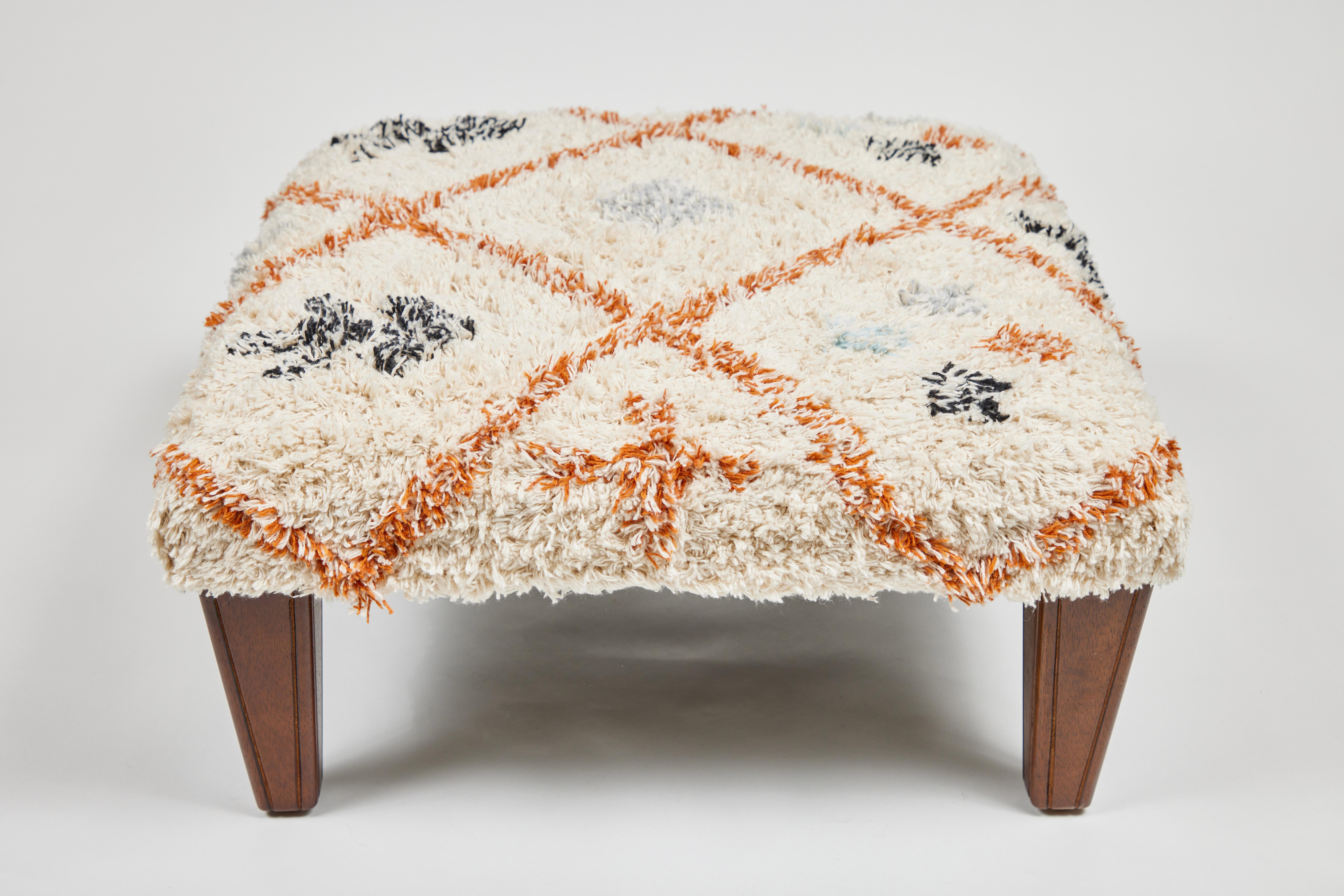 Custom footstool with new wood legs and covered with a cotton textile from India.
 It measures 19