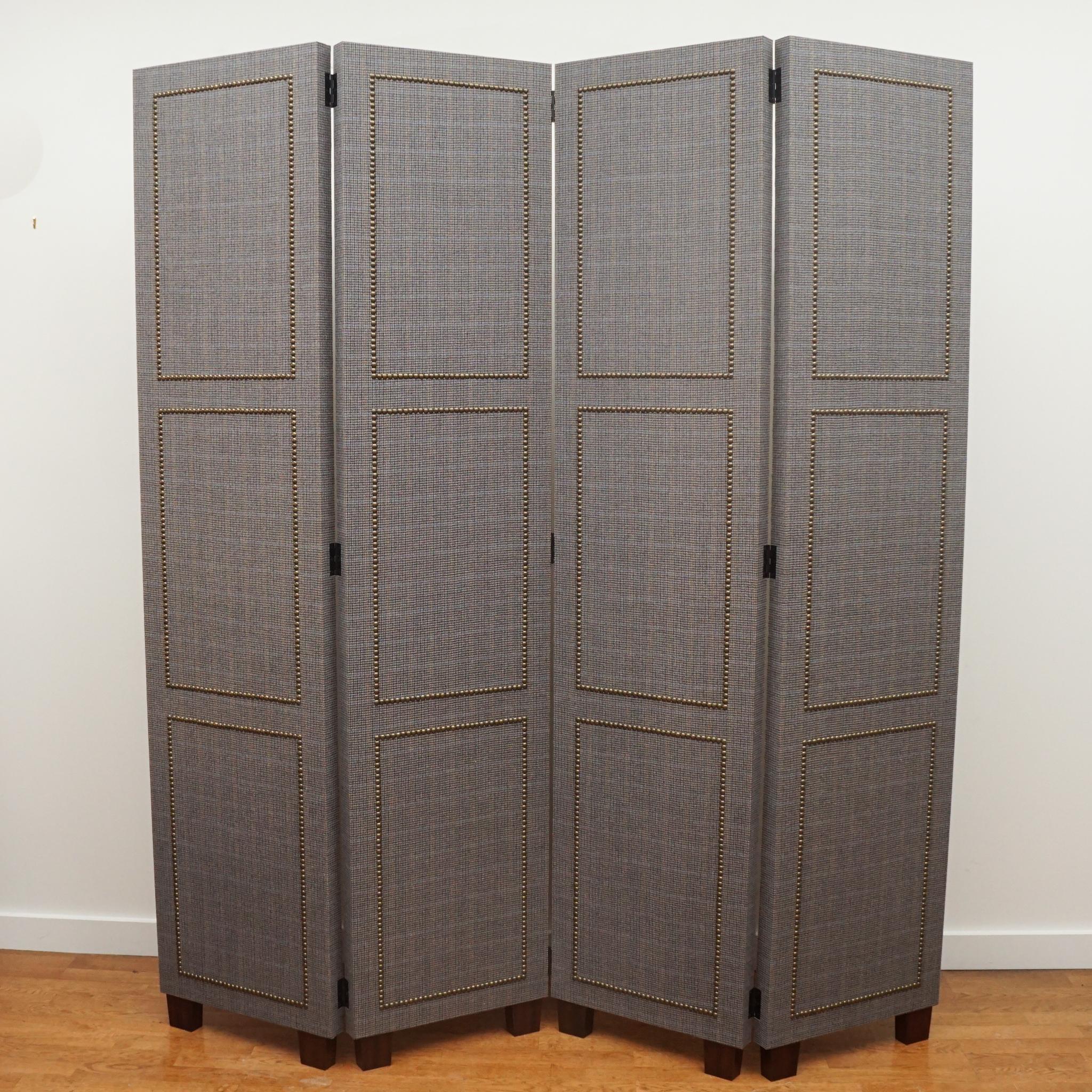 This custom-made, four-panel room divider is finished with an American Wool plaid fabric and detailed with antique brass nail heads. Each panel measures 18