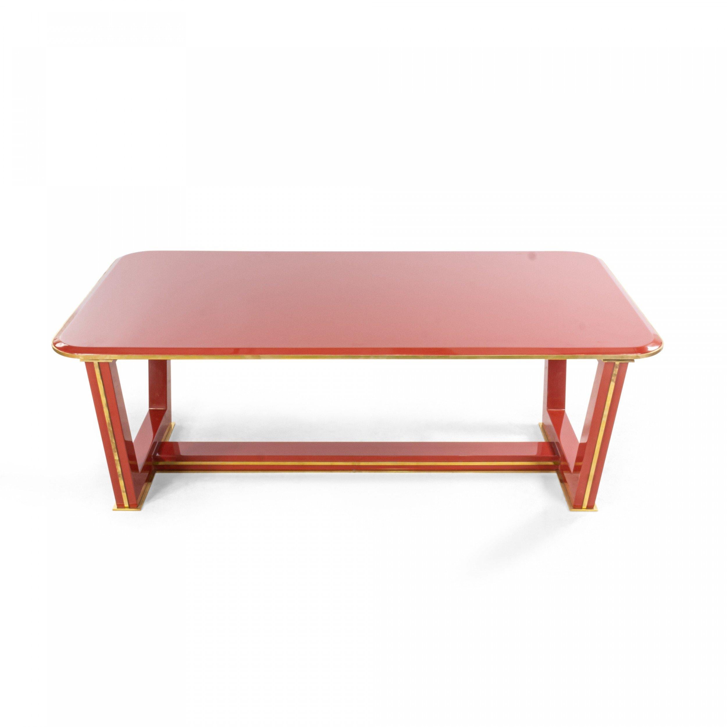 Customizable French 1940s style (modern) red lacquered coffee table with a rounded corner rectangular top with brass trim, four legs, and stretcher base.
     