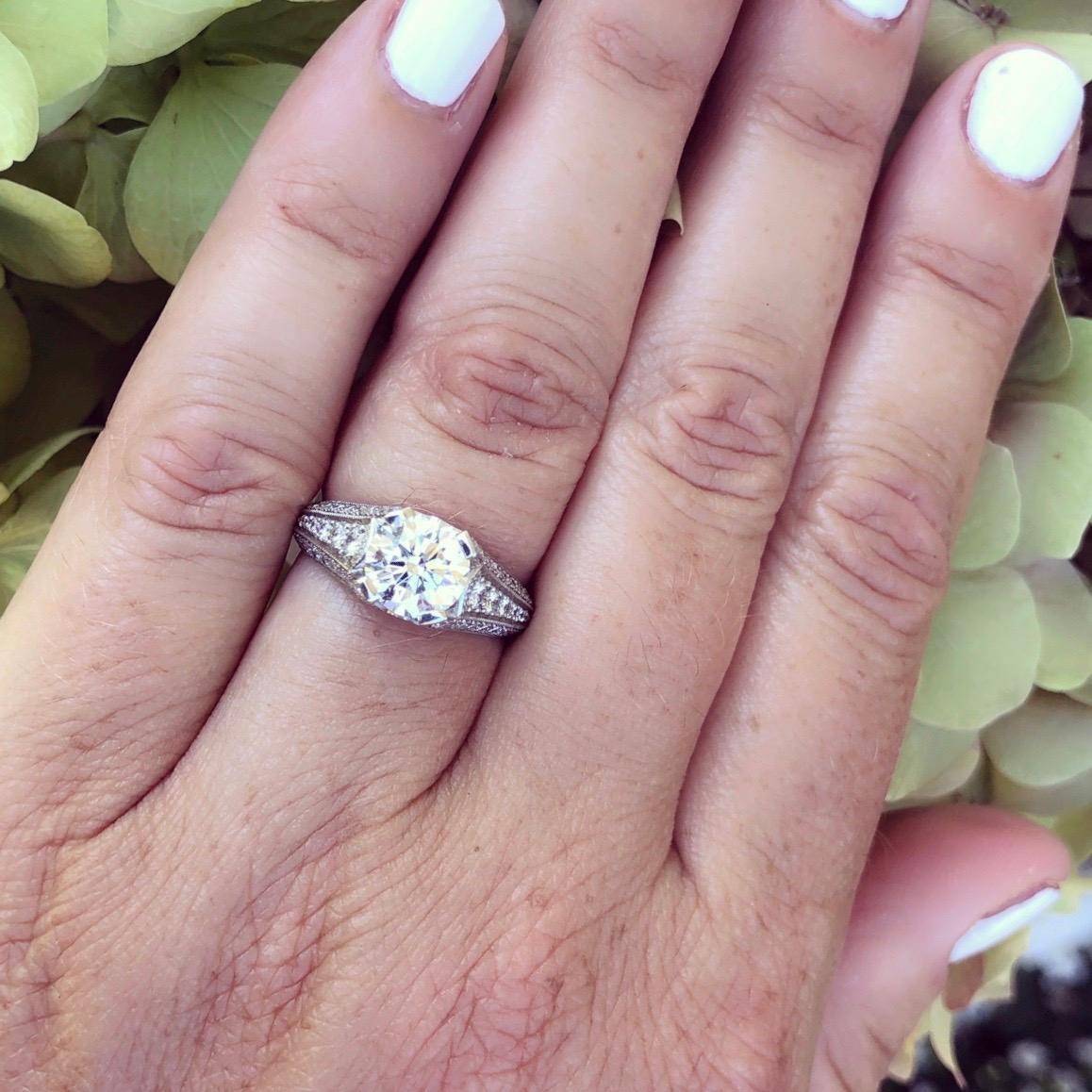Modern day quality craftsmanship meets timeless design in this beautiful Custom French platinum ring features a 1.55ct round brilliant cut diamond with G color and VS1 clarity accented by 60 round brilliant cut diamonds for approximately 0.73cts.
