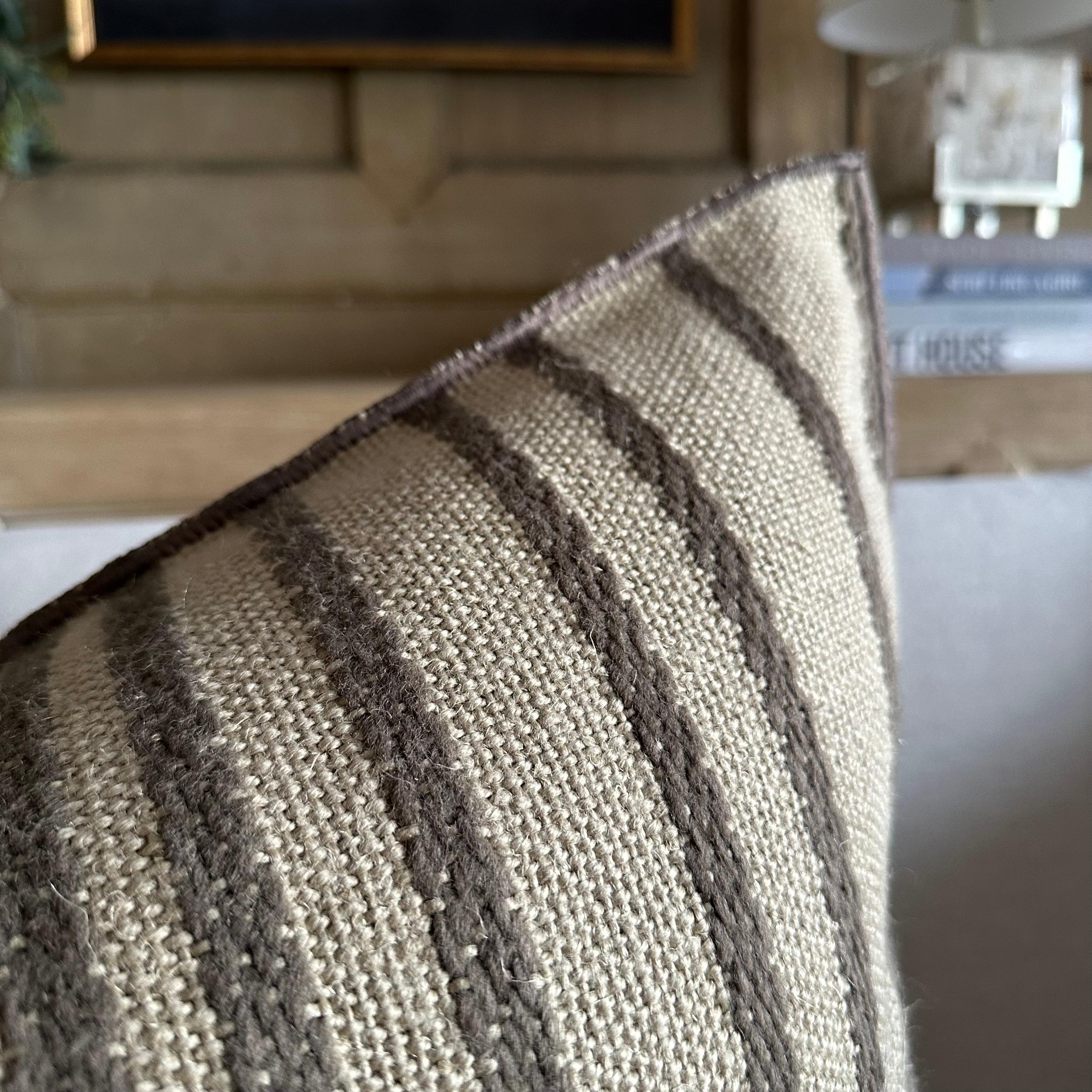 MDV Embroidered Myre Rayure 
Color: Ecorce (a bronze with gray hues)
Size 20x27
A beautiful natural flax, heavy weight linen, with a deep dark gray bronze embroidered stripe pattern. 
These pillows are crafted from a luxurious wool, and linen blend,