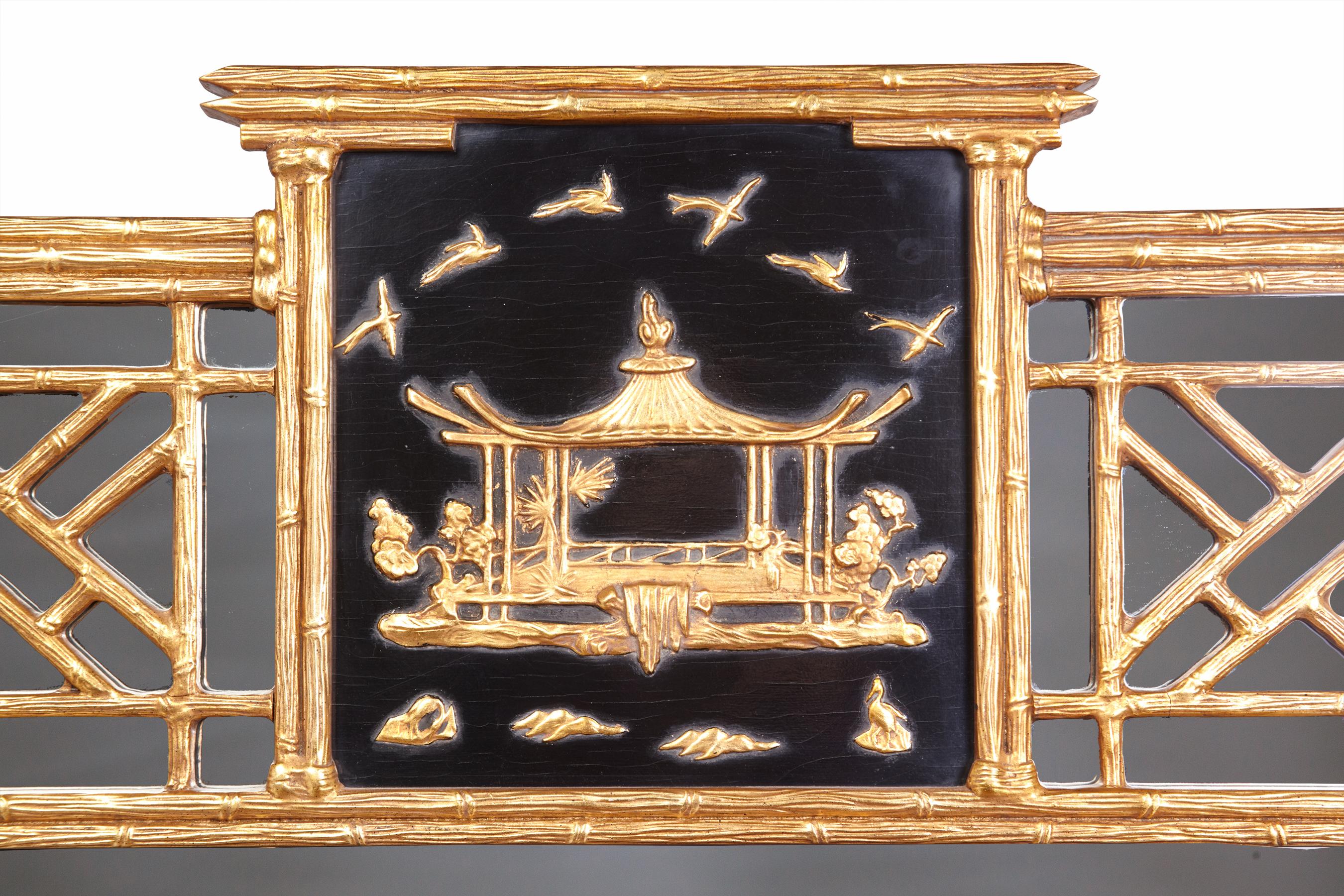 Dramatic large 20th century custom made Friedman Brothers Mirror. The beveled mirror is framed in gold faux bamboo topped with a gold pagoda set against a black background.
Pleasing dimensions make it a stunning addition to any room. In excellent
