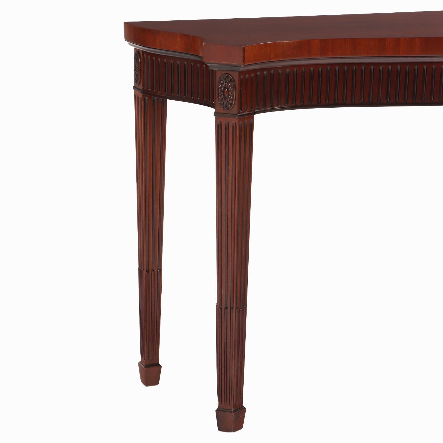 Custom mahogany Georgian style console table having a serpentine shaped top and conforming apron with ebonized flutes and Greek key design. The underside stamped 