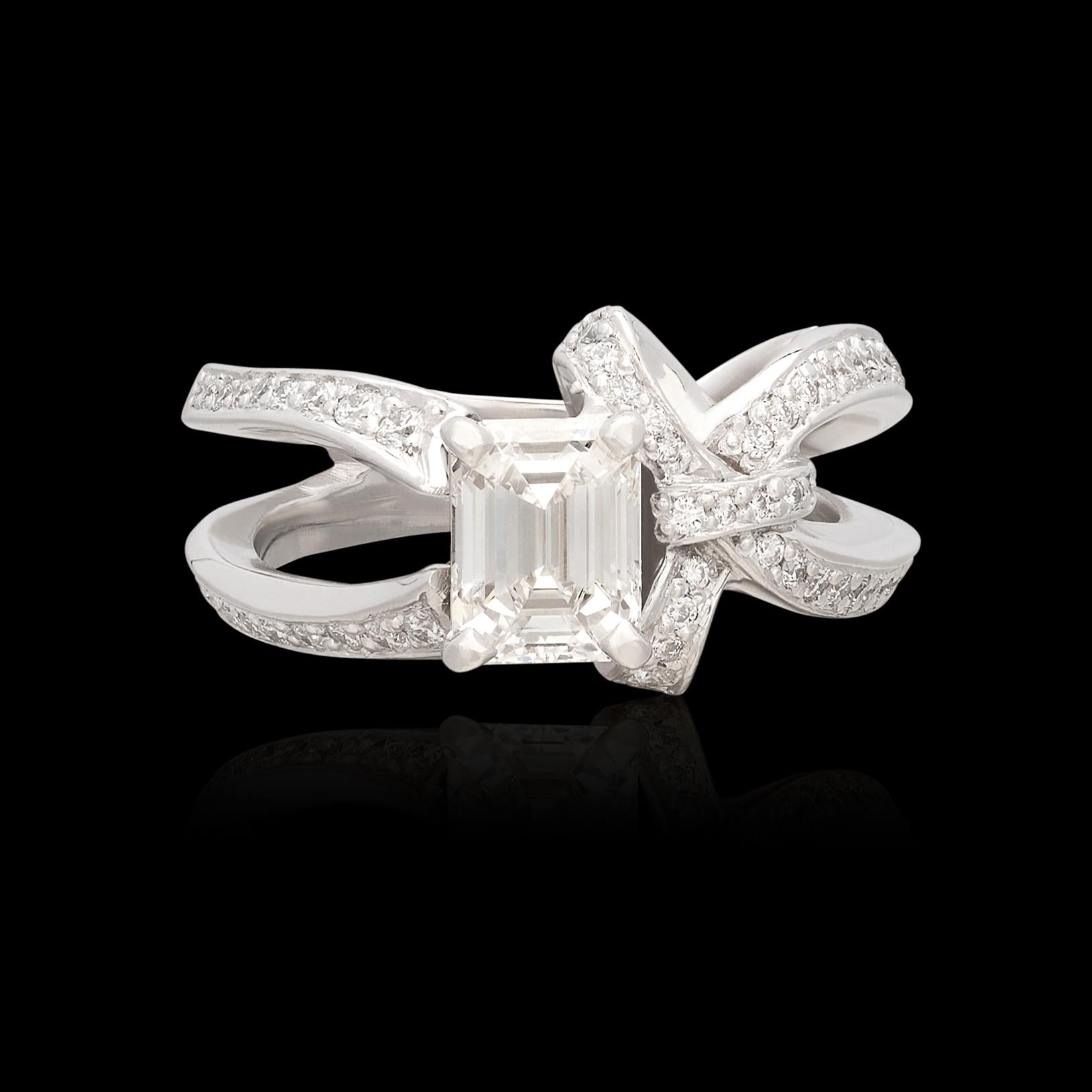 A truly unique twist on an engagement ring, featuring a truly special diamond. This white gold beauty showcases an incredibly fine 1.21 carat Emerald Cut Diamond graded by the Gemological Institute of America as F color and VS1 clarity (GIA report