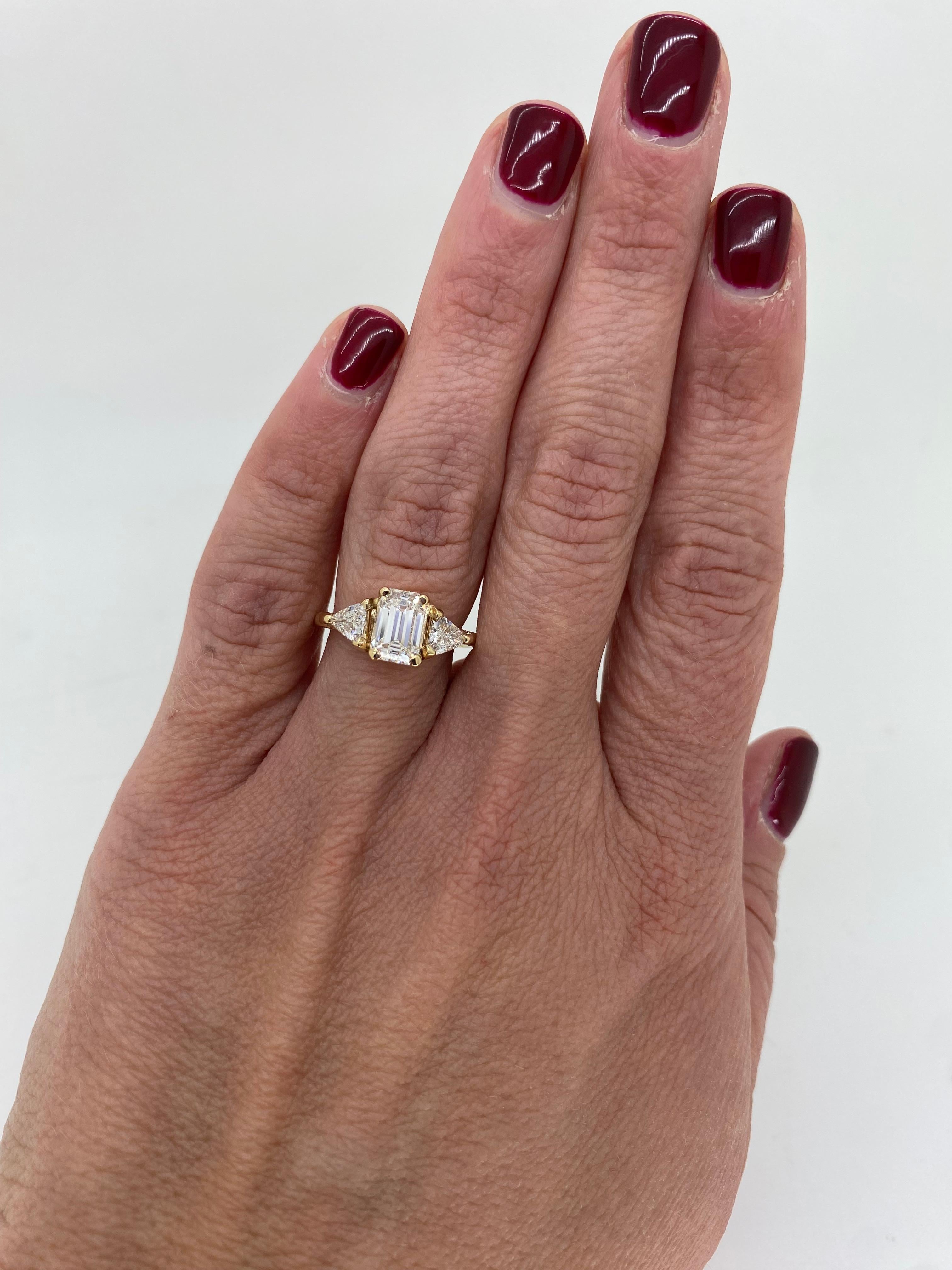 Custom three stone 1.33CTW Certified Emerald Cut Diamond engagement ring made in 14k yellow gold. 

Center Diamond Carat Weight: 1.33CT
Center Diamond Cut: Emerald
Center Diamond Color: F
Center Diamond Clarity: VS2
Certification: GIA