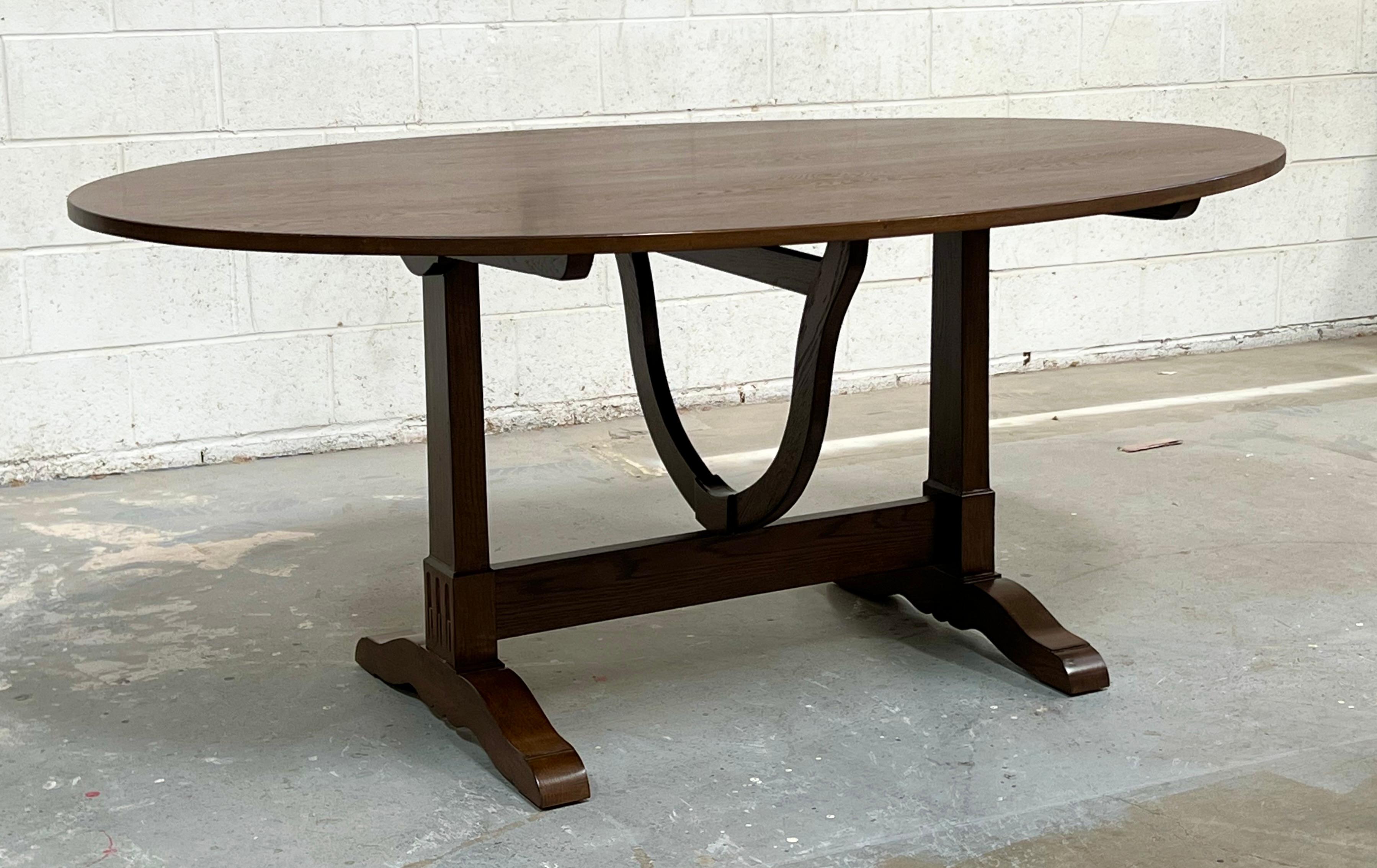 This super ellipse dining table with a single pedestal is made from walnut and is seen here in 84