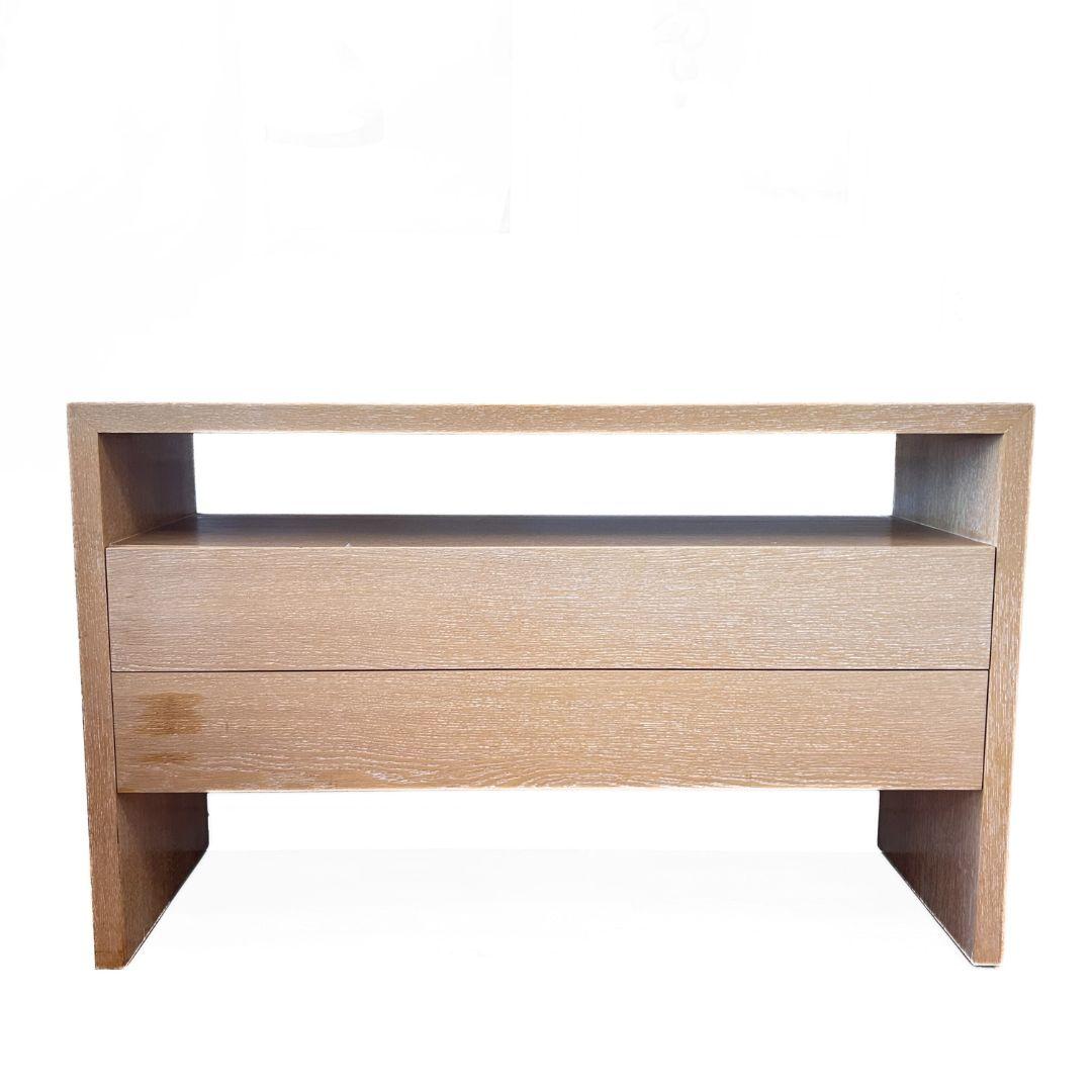Modern Parsons style teak console with two drawers and one open shelf. Drawers have a fluted edge pull. Shown in oil-rubbed teak. Custom finishes also available in light cerused oak, white or black lacquer.

Lead Time: 6-8 Weeks 

width: 60