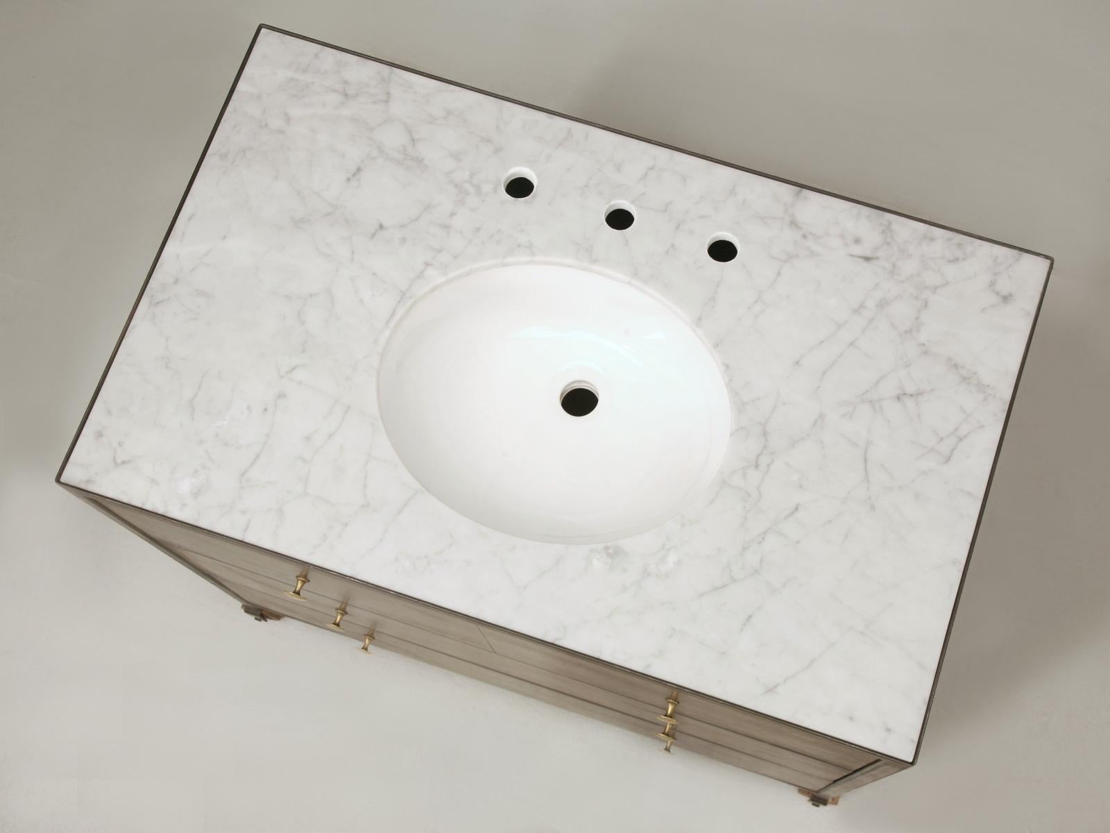 French industrial style steel clad commode or sink base custom made by our Old Plank craftsmen. The interior is wood and can be painted any color. It can be made in any size as a commode or a vanity - the price shown does not include a marble top