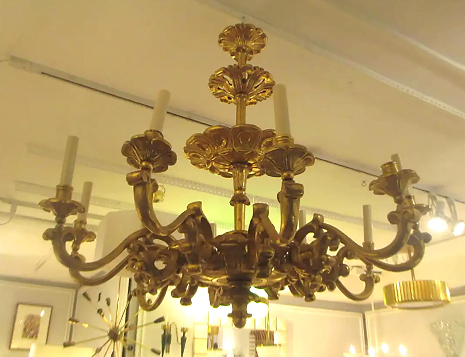 An exquisitely hand carved giltwood eight-arm chandelier in the baroque manner. Please note that this piece is customizable. Lead time is 8-10 weeks.