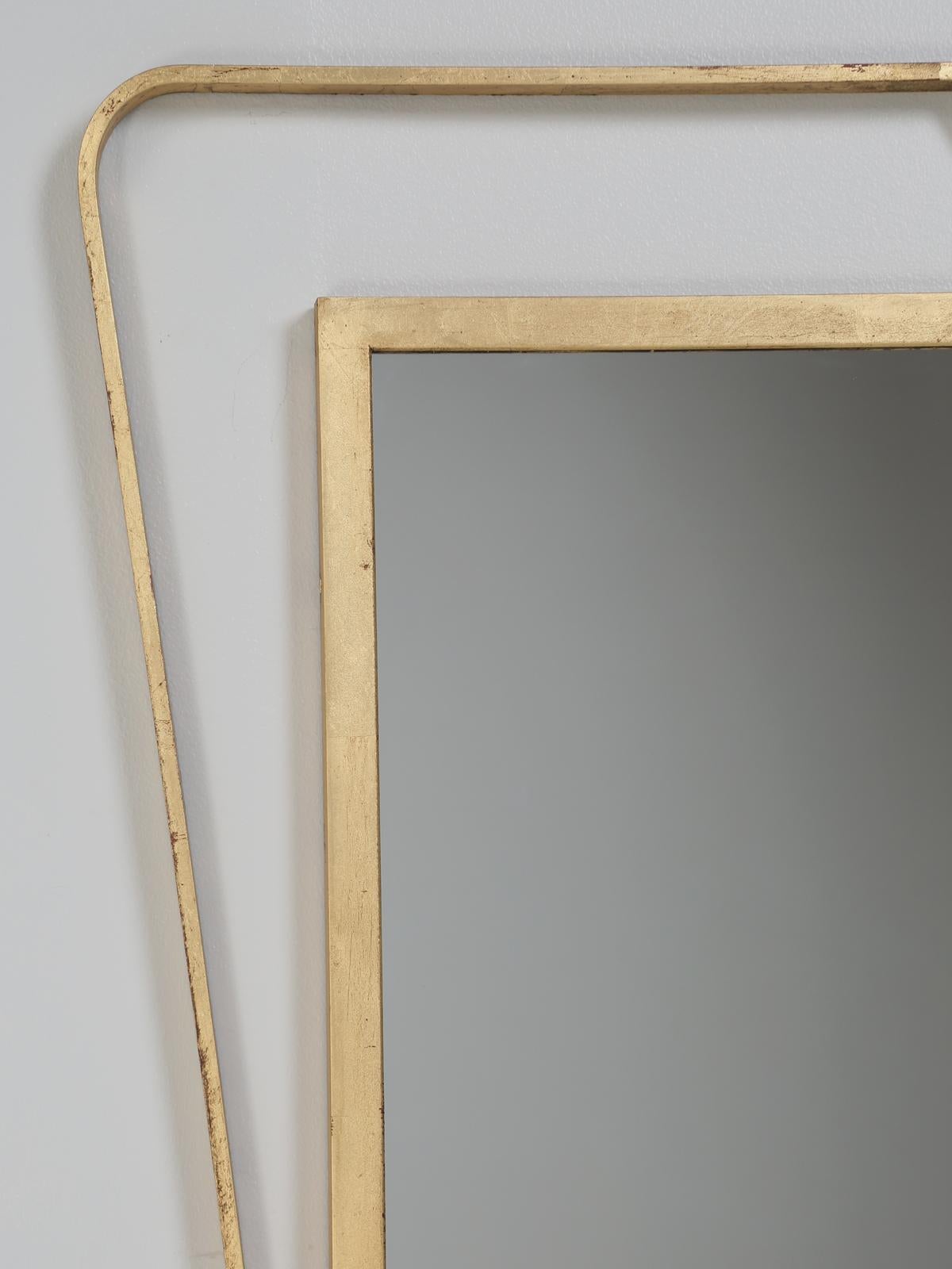 Custom made wall mounted Mid-Century Modern mirror by Old Plank in the dimension of your choosing. Listed is our hand-applied old fashion gilt finish with the red undertones, although you can spec out whatever finish you would like on our modern