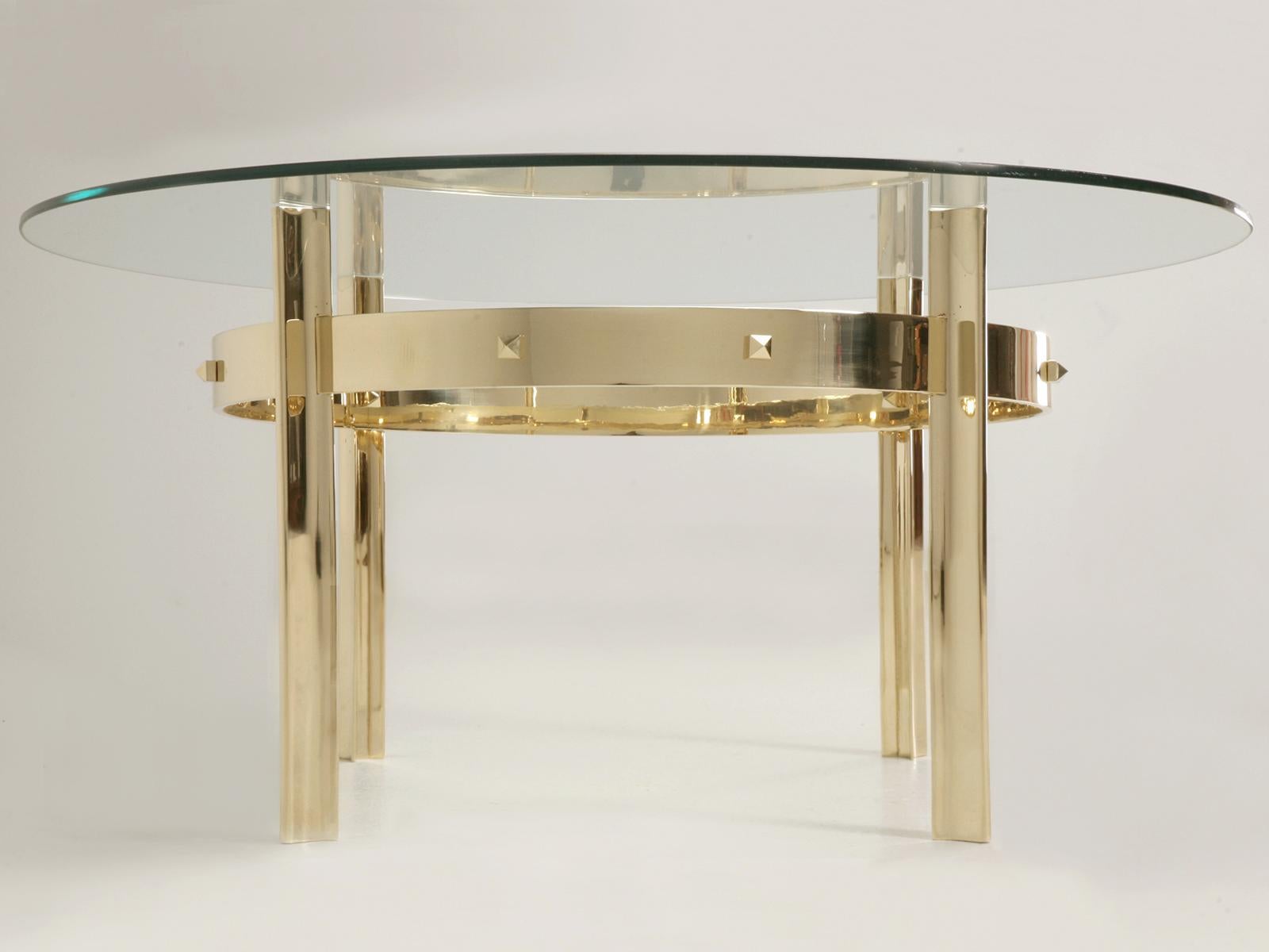 Custom Hand-made of Solid Brass and available as both, a Coffee Table, Dining Room Table or Center Hall height. The four grooved legs are connected with a highly polished band offering not only stability, but adding a bit more style to this already