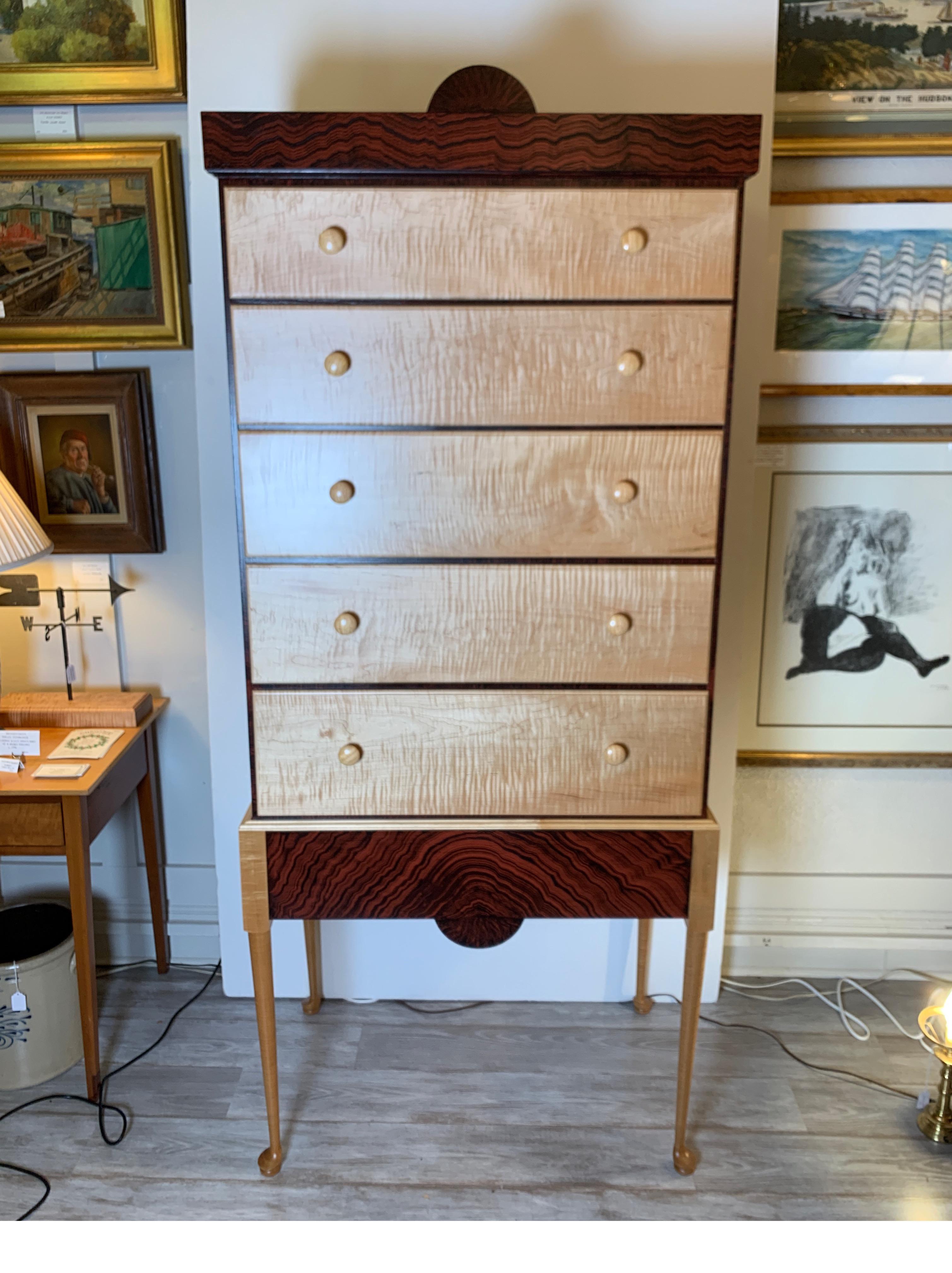 Bench made, handcrafted chest on frame, made in 1984. Five graduated tiger maple drawers on tiger maple legs, cabinet with painted decoration.  Signed by maker.