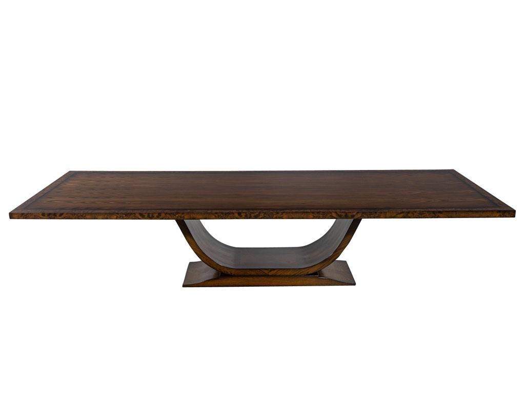 Custom Handcrafted Modern Art Deco walnut dining table. This hand-crafted custom table is made and finished from scratch by our master craftsmen. It features an original Art Deco inspired curved pedestal. With an absolutely gorgeous tabletop