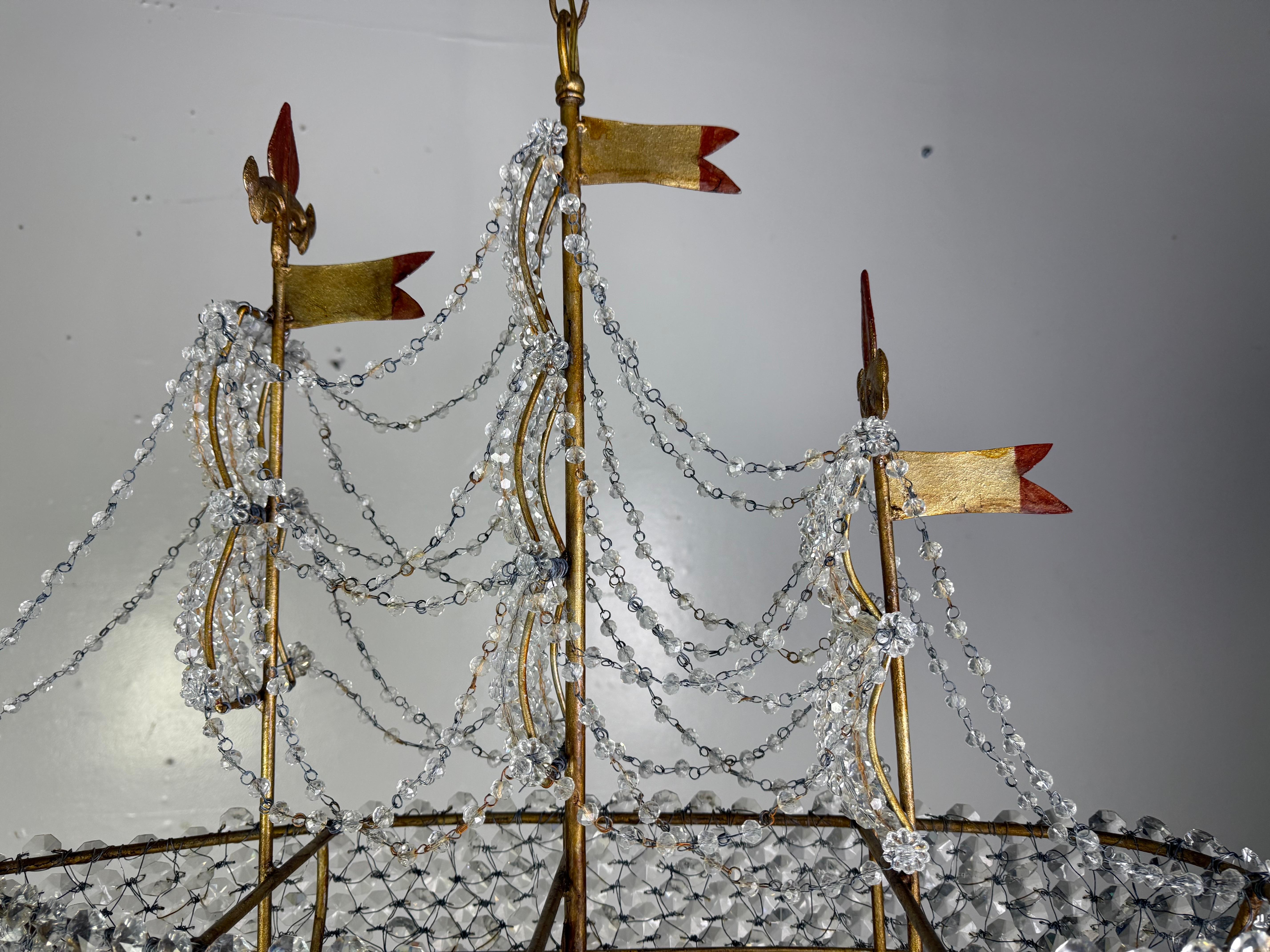 This exquisite ship-form chandelier is a custom creation by Miamar Home, an atelier based in Los Angeles renowned for its collaboration with the city’s finest local artisans. Entirely handmade, the chandelier is meticulously crafted with hundreds of