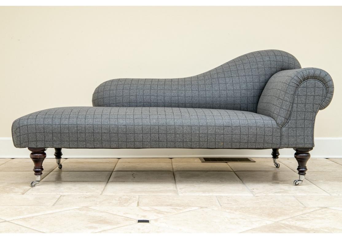 Labeled special size, Elphinstone 72, handmade in England. One of the line's elegant comfortable chaises, here in a contemporary upholstery in dark gray felt like fabric with black windowpane cross stitching. With a classic rolled back and a shaped