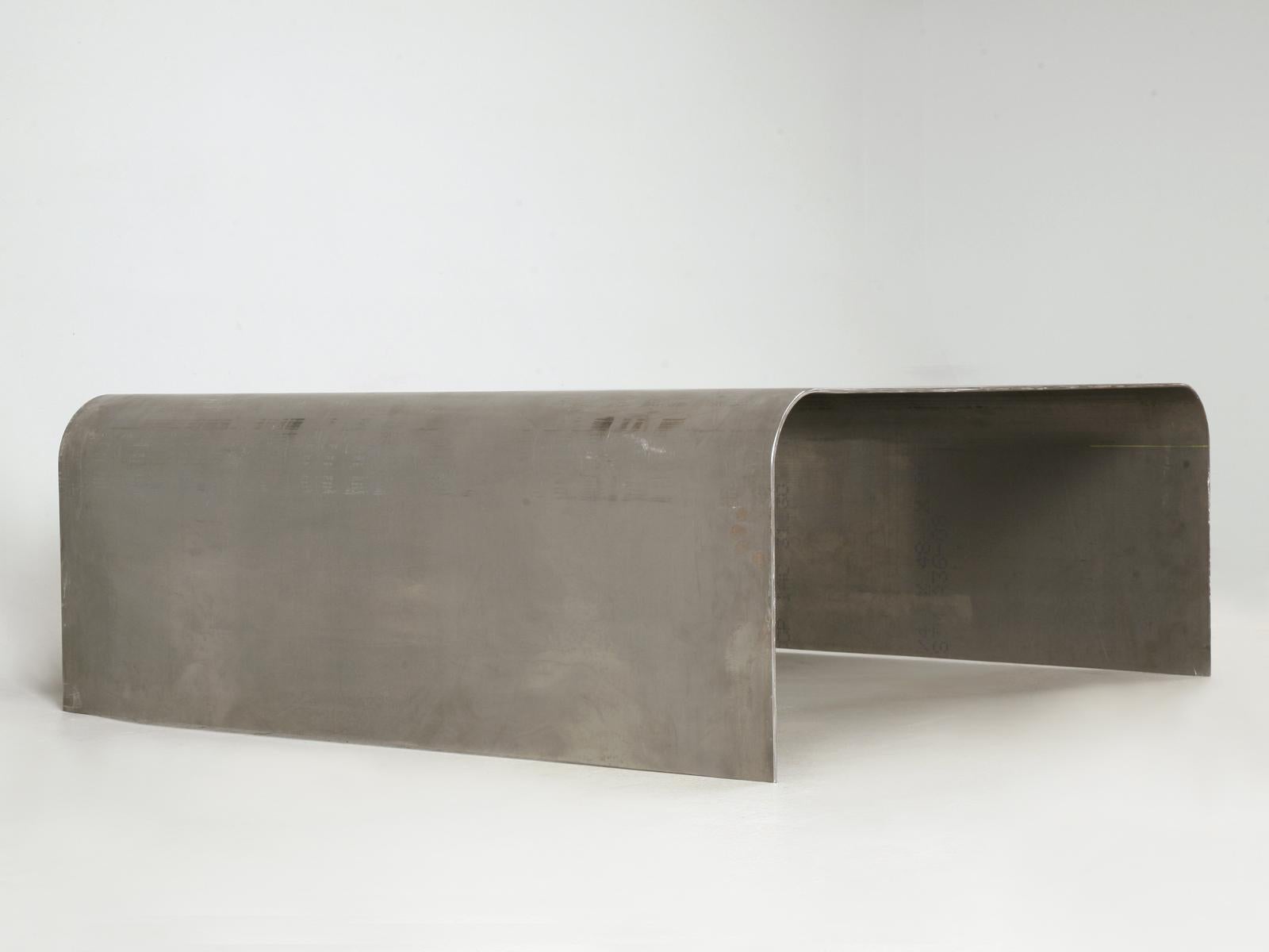 The steel has a low sheen with artifice nicks 'n' scratches, which makes the Industrial style coffee table appear more rustic than reflective. A quarter-inch thick solid cold roll steel plate that we coated with a clear protective coating that keeps