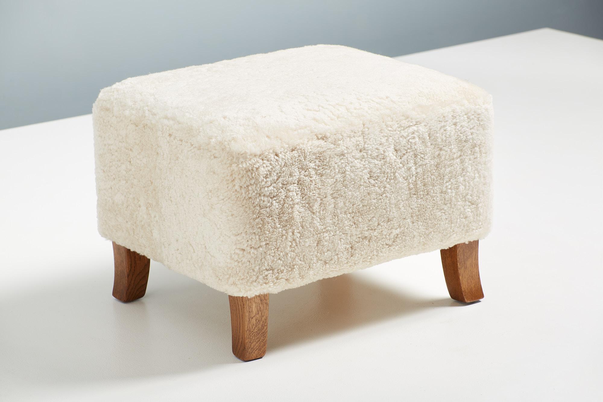 Dagmar Design - Sampo Ottoman

A custom-made ottoman designed & produced at our workshops in London using the highest quality materials. This example is upholstered in Moonlight sheepskin with carved feet in fumed oak. This ottoman is available to