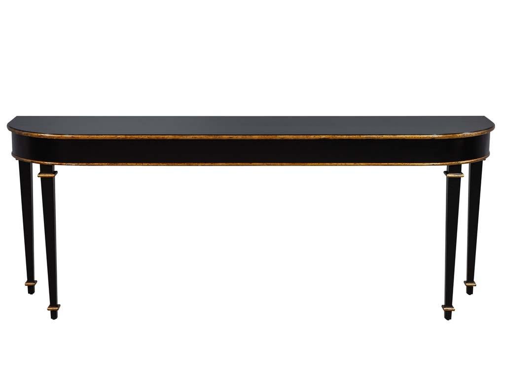 Carrocel custom made console table, elegantly designed and proportioned with classic flowing tapered legs beautifully finished in a crackle satin black finish with rich gold leaf high lights to accentuate the fine detail of this understated elegant