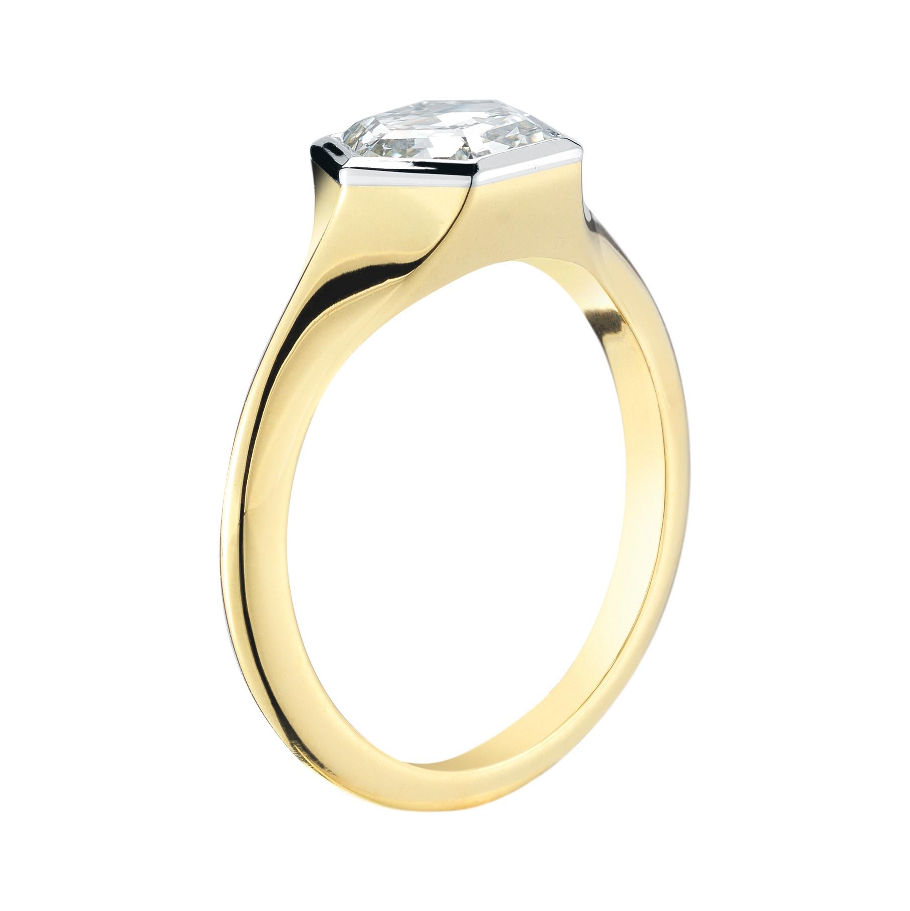 Custom Hexagon Diamond Engagement Ring. This sparkly step cut diamond is framed with platinum to enhance the size of the stone. The platinum bezel is fused to an 18k yellow gold knife edge band for an elegant and timeless look. 

Each ring is