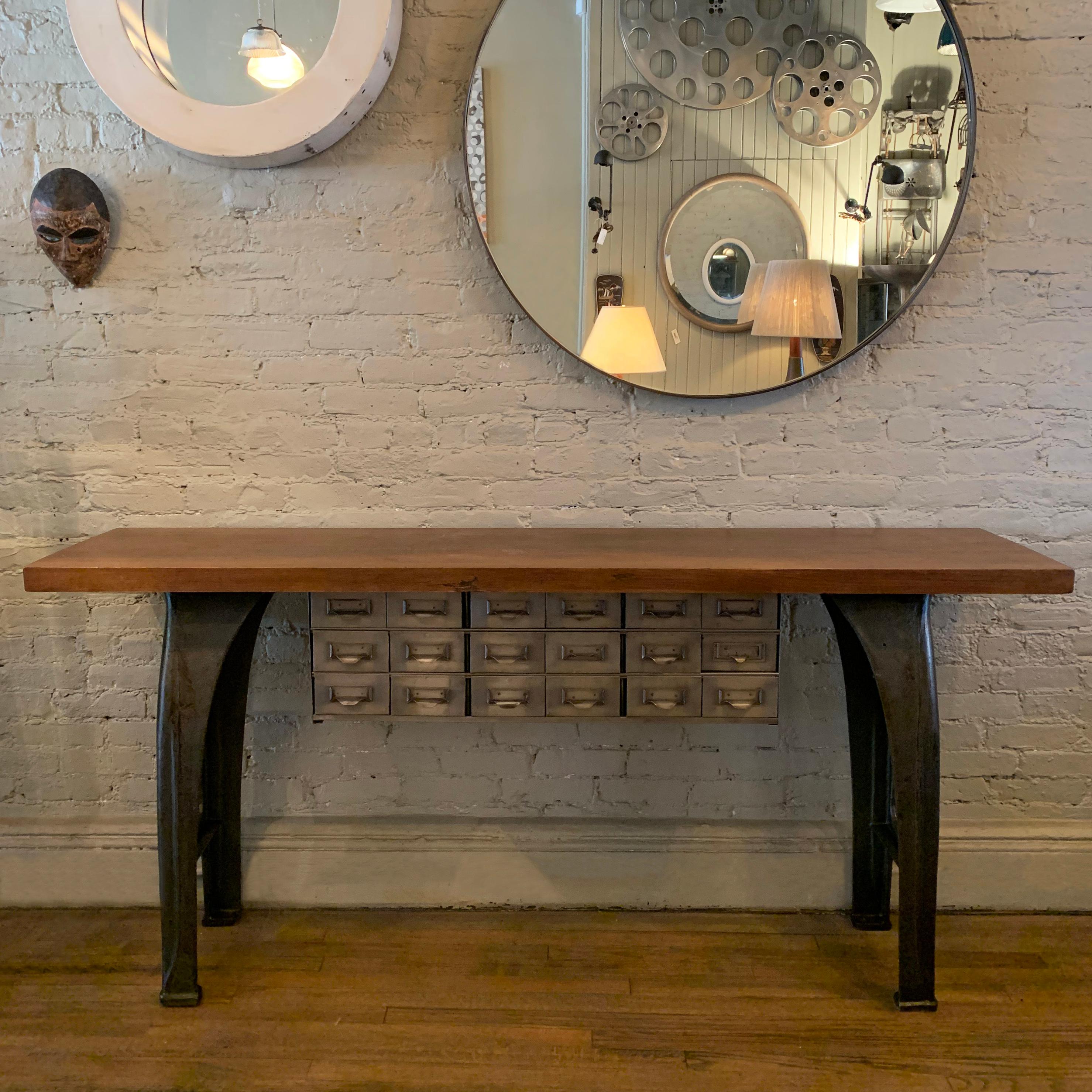 Custom, industrial, console table features cast iron legs and reclaimed, maple block top with steel index cabinet storage. The 18 steel drawer section measures 33.75 W x 11 D x 34 H and each drawer is 5.5 W x 11 D x 3 H.