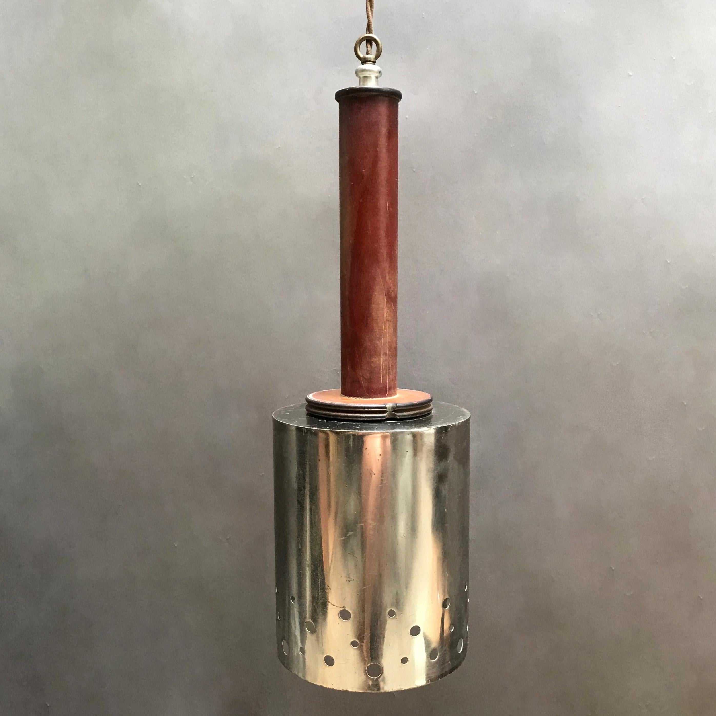 Custom, industrial pendant light assembled from vintage components features a perforated, chrome plated steel shade with masonite stem is wired with 70 inches of braided beige cloth cord with plug to accept up to 100 watt bulb.