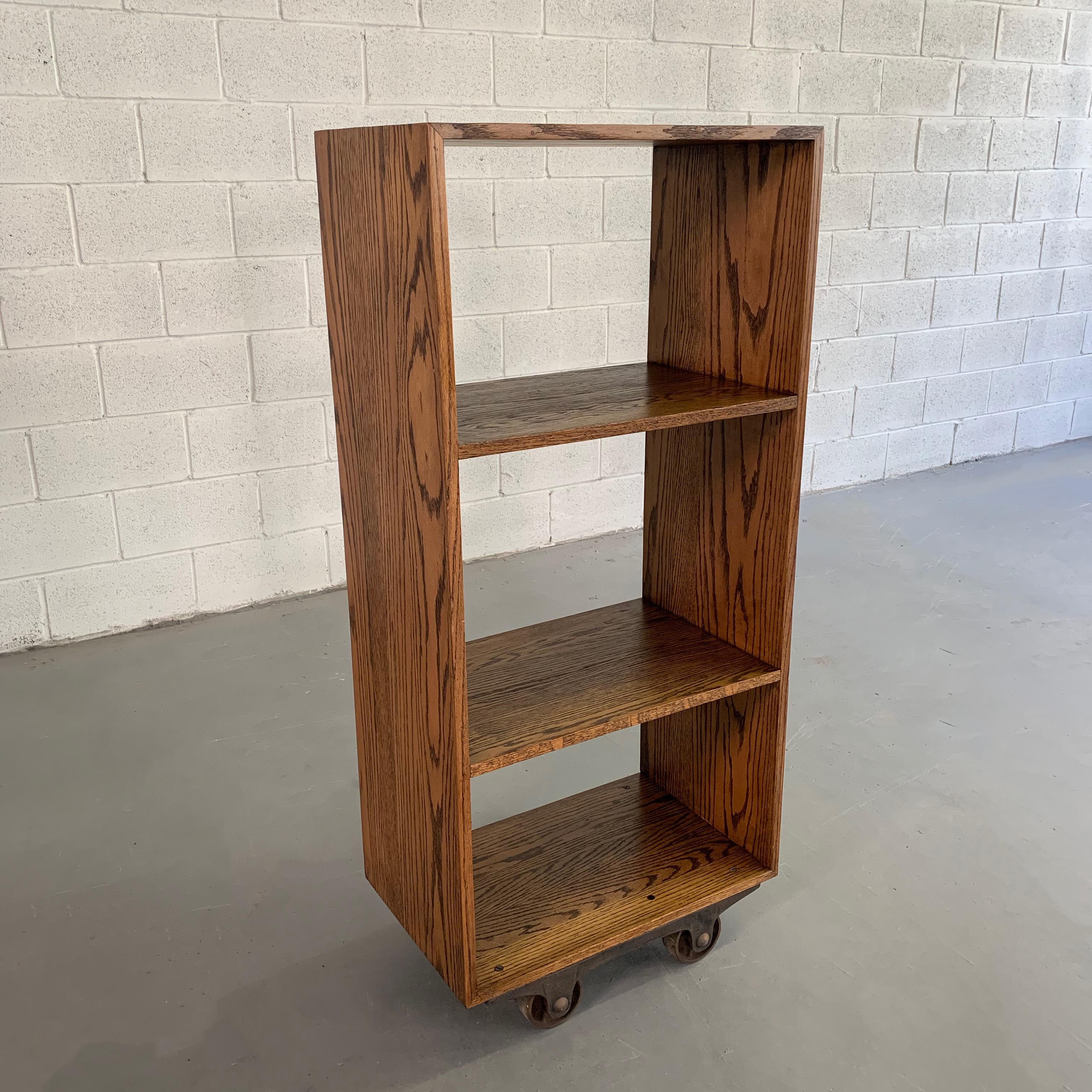 Custom, industrial, solid ash, open bookcase or shelf unit features 3 fixed shelves with top and bottom sections at 14 inches height and middle section at 17 inches height. The unit rolls on antique cast iron casters. CF Signature custom made in