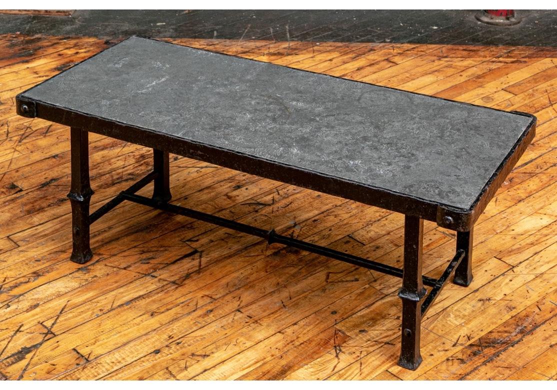 With an elemental Industrial Era form, very well made in great condition. Rectangular with attached cast faux slate top. There is some paint loss as well as rust spots which do not detract from the fine presentation. 
Measures: 41.5” wide by 18”