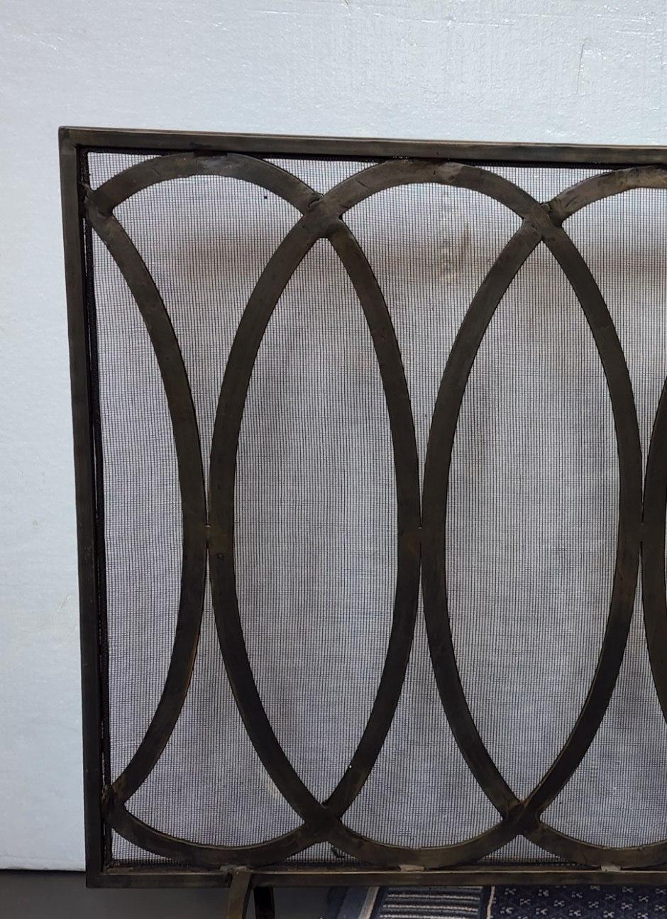 Oval overlap iron pattern fire screen.