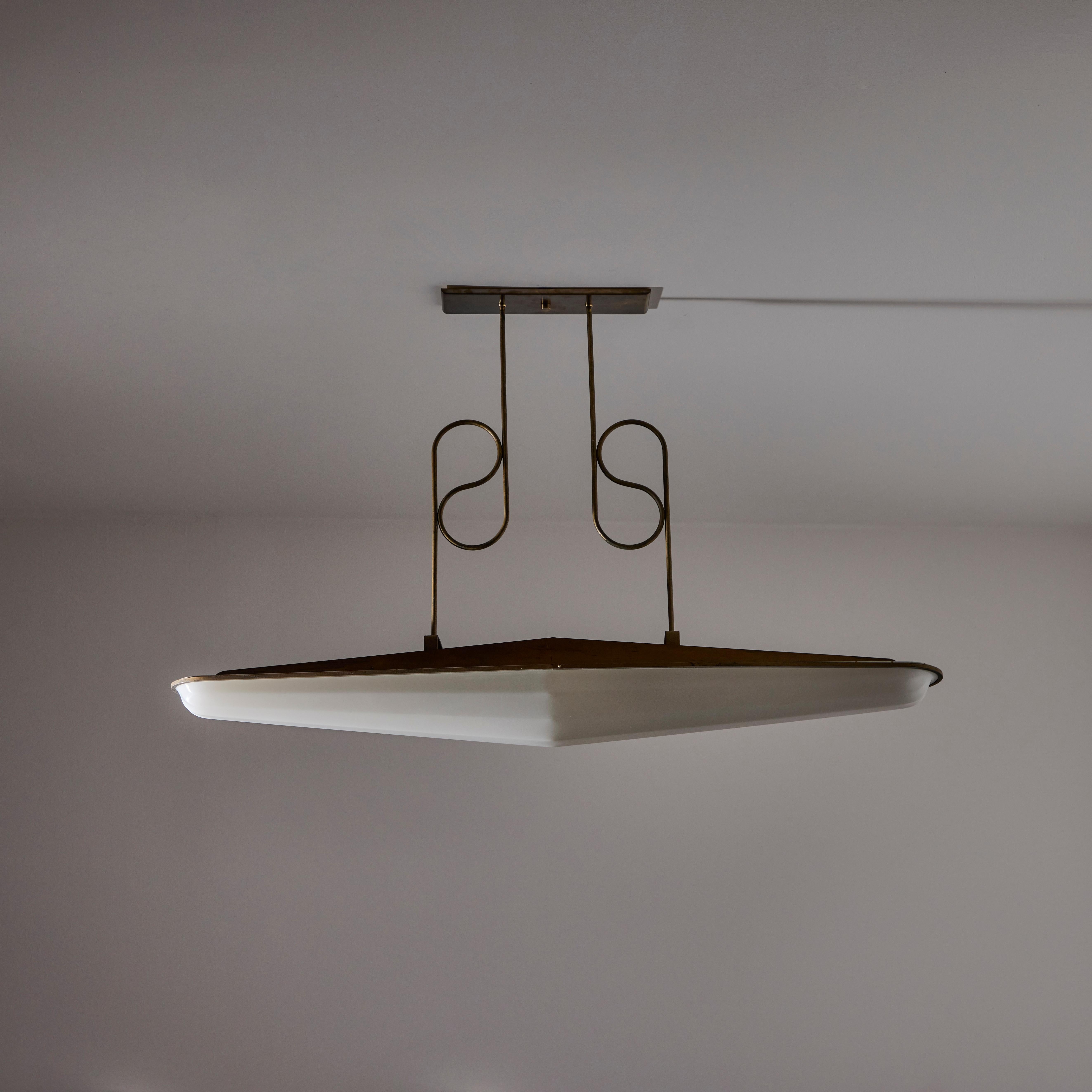 Custom Italian Ceiling Lights. Designed and manufactured in Italy, circa the 1950s. These linear ceiling lights were uninstalled from an Italian movie theatre in the 20th century. Aged brass bent piping and lucite white acrylic diffusers. The trio