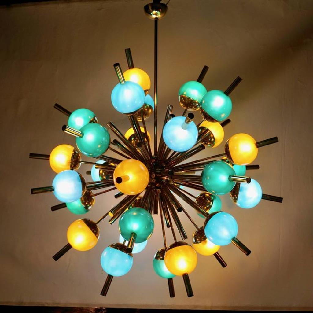 A bespoke contemporary thirty-light Italian light fixture, with Mid-Century Modern design, entirely handmade, with a Sputnik brass structure; gold brass rods are jutting out of a central sphere in a starburst pattern, some shorter and some decorated