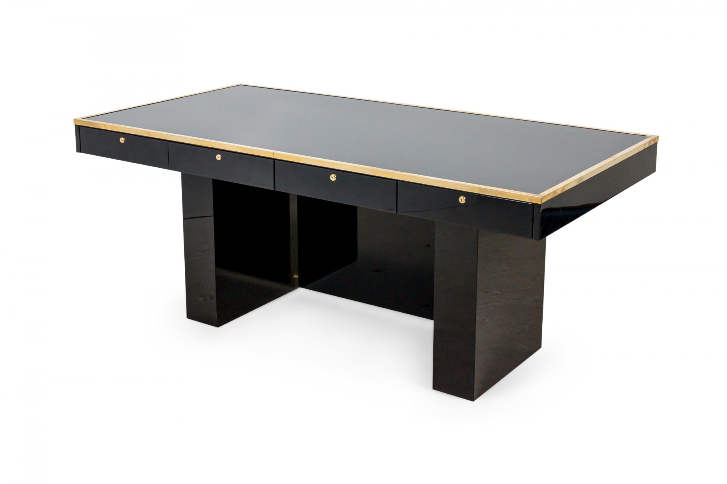 Italian mid-century style black lacquered desk with brass trimmed edge and 4 drawers supported on 2 rectangular pedestals centering a vanity panel. Done in the style of Aldo Tura (can be customized in size and color).