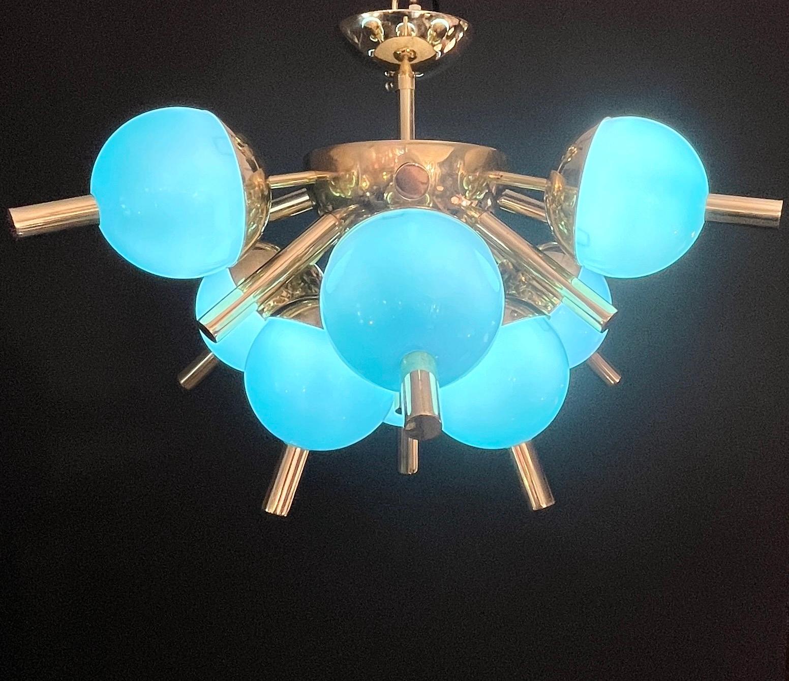 Who says that a small chandelier cannot be TOTAL FUN?! A bespoke contemporary thirteen-light Italian half sputnik fixture, with Mid-Century Modern design, entirely handmade in Italy, with a brass structure; gold brass rods are jutting out of a
