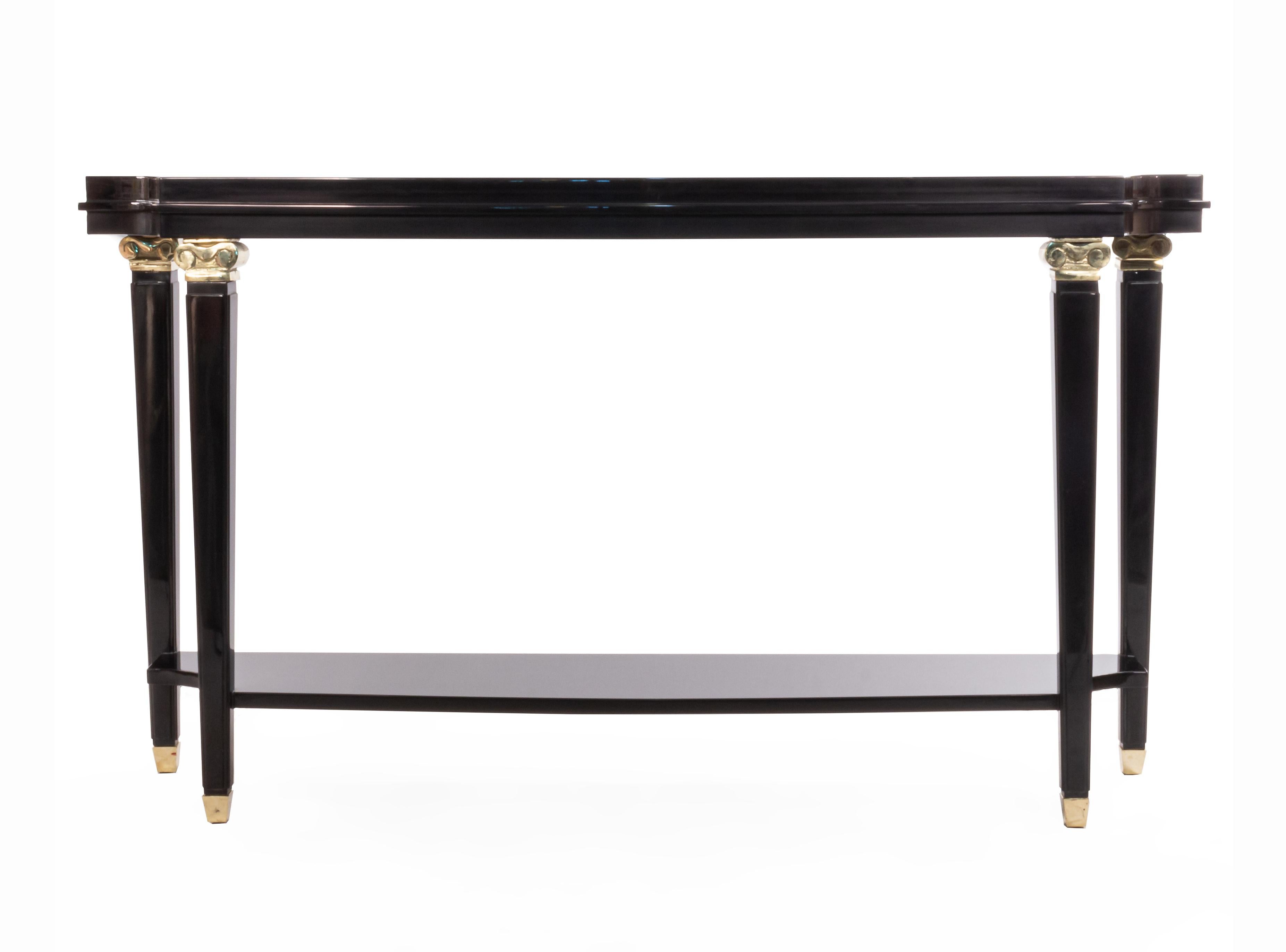 French 1940s Lucien Rollin-style black lacquer shaped top console table with shelf and bronze capital trim on legs.