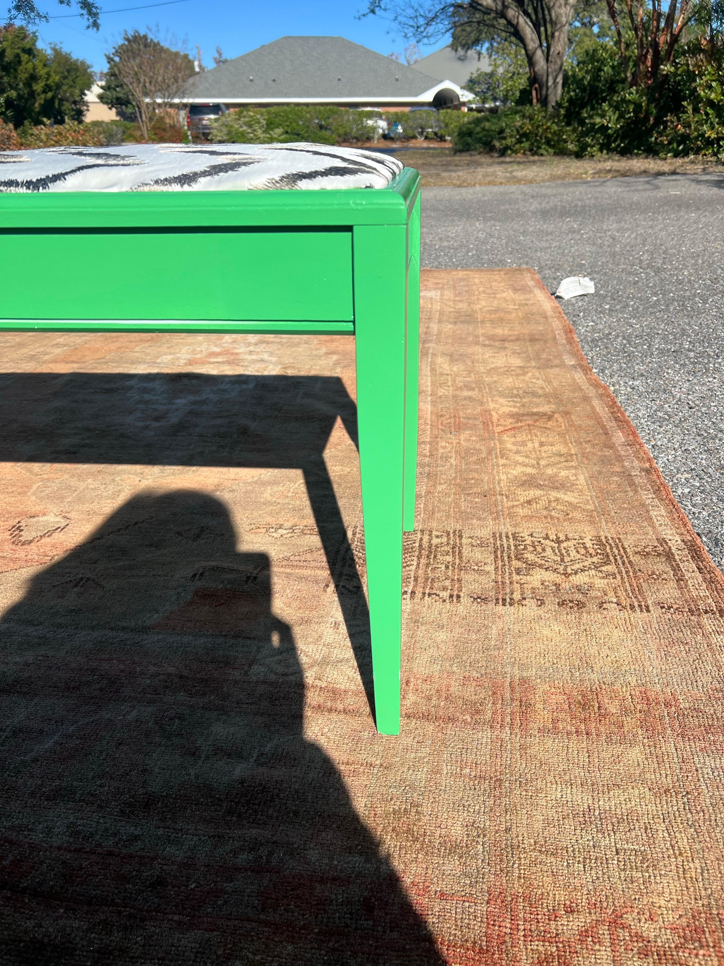 Antique piano bench lacquered in a gloss Kelly green.  Newly upholstered in Donghia embroidered zig zag silk satin fabric.  