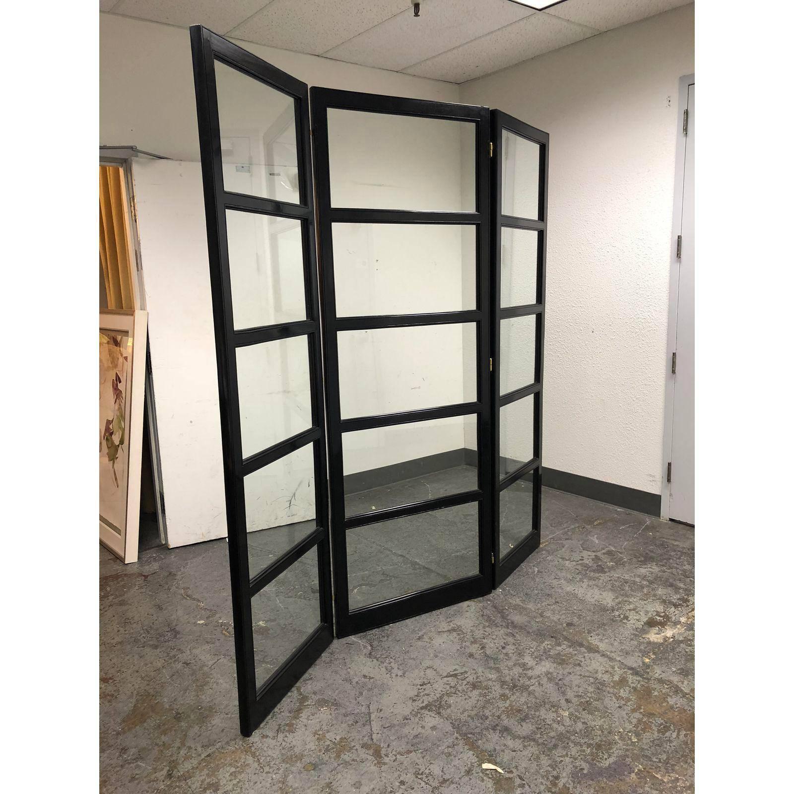 A three panel folding screen. The frame has a dar ebonized finish which really set of the clear glass panels. 
Original Price: $3,277.50.
   
