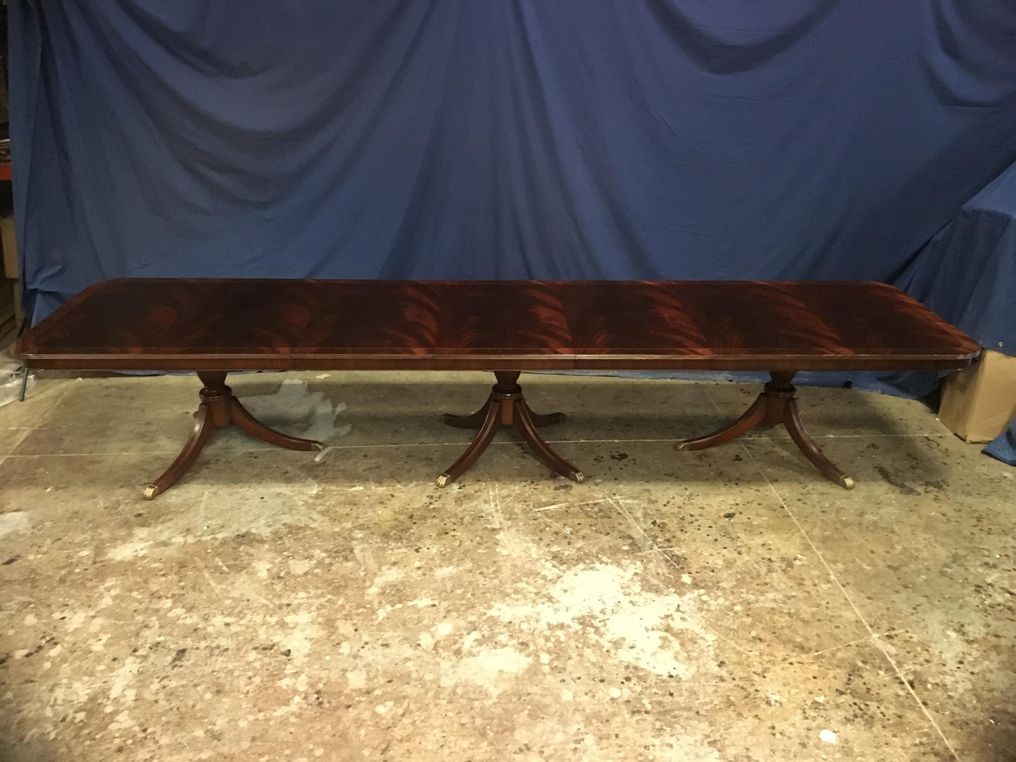 This is a made-to-order large traditional mahogany banquet/dining table made in the Leighton Hall shop. It features a field of slip-matched swirly crotch mahogany from west Africa with a contrasting border separated by an ebony and white maple Inlay