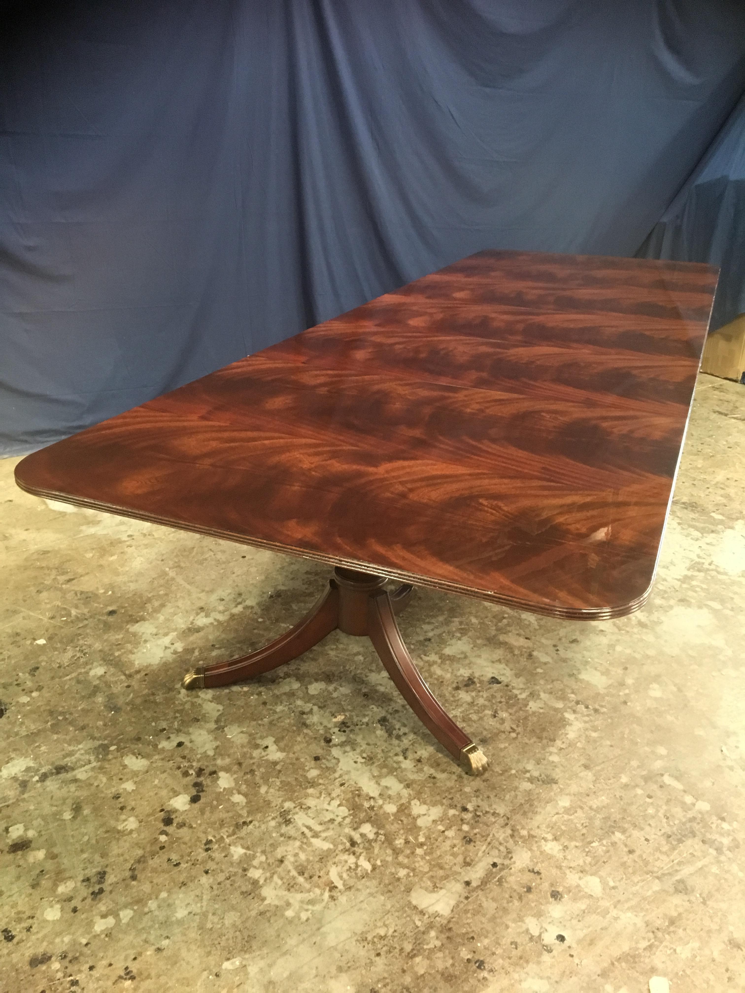 This is a made-to-order large traditional mahogany banquet/dining table made in the Leighton Hall shop. It is modeled after the understated swirly crotch mahogany tables made in the 1800s and early 1900s. It features a field of slip-matched swirly