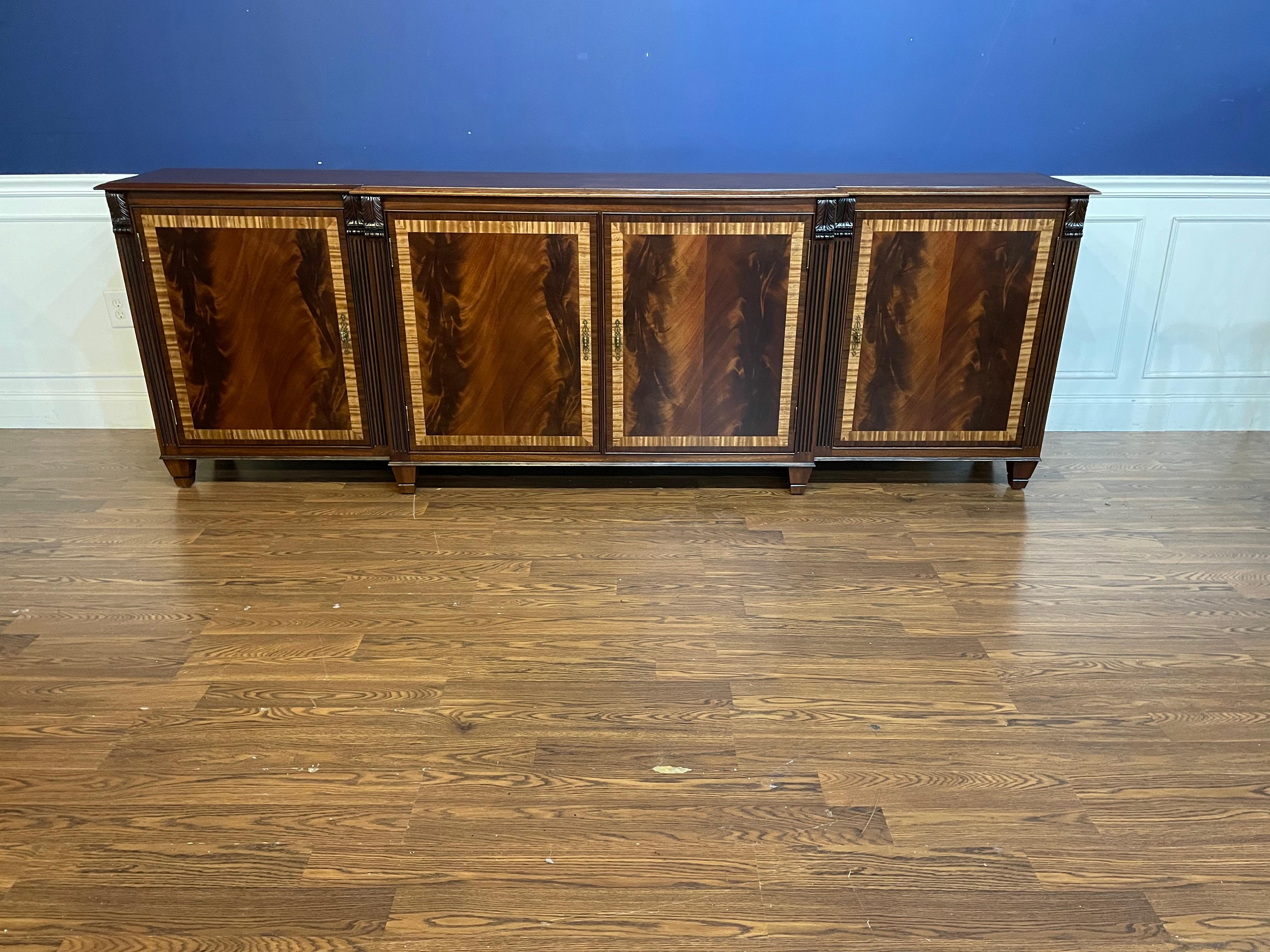 This is made-to-order traditional mahogany four door buffet or credenza made in the Leighton Hall shop. It features four doors with reverse-slip-match swirly crotch mahogany fields and Satinwood and Santos Rosewood (Pau Ferro) borders. It has a