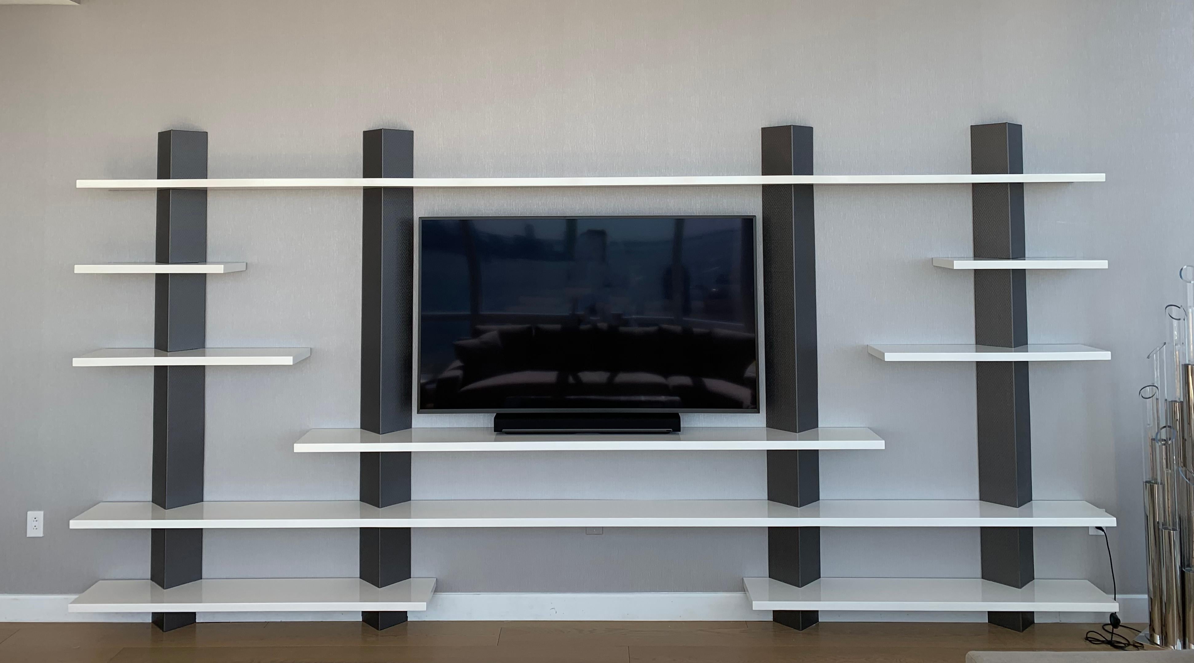 Our La Scalia shelving unit is a large custom built bookshelf with four pillars supporting floating shelves. Each pillar is wrapped in a textured vinyl that comes in five different color ways: Platinum, Silver, Rose Gold, Old Bronze and Iron. Each