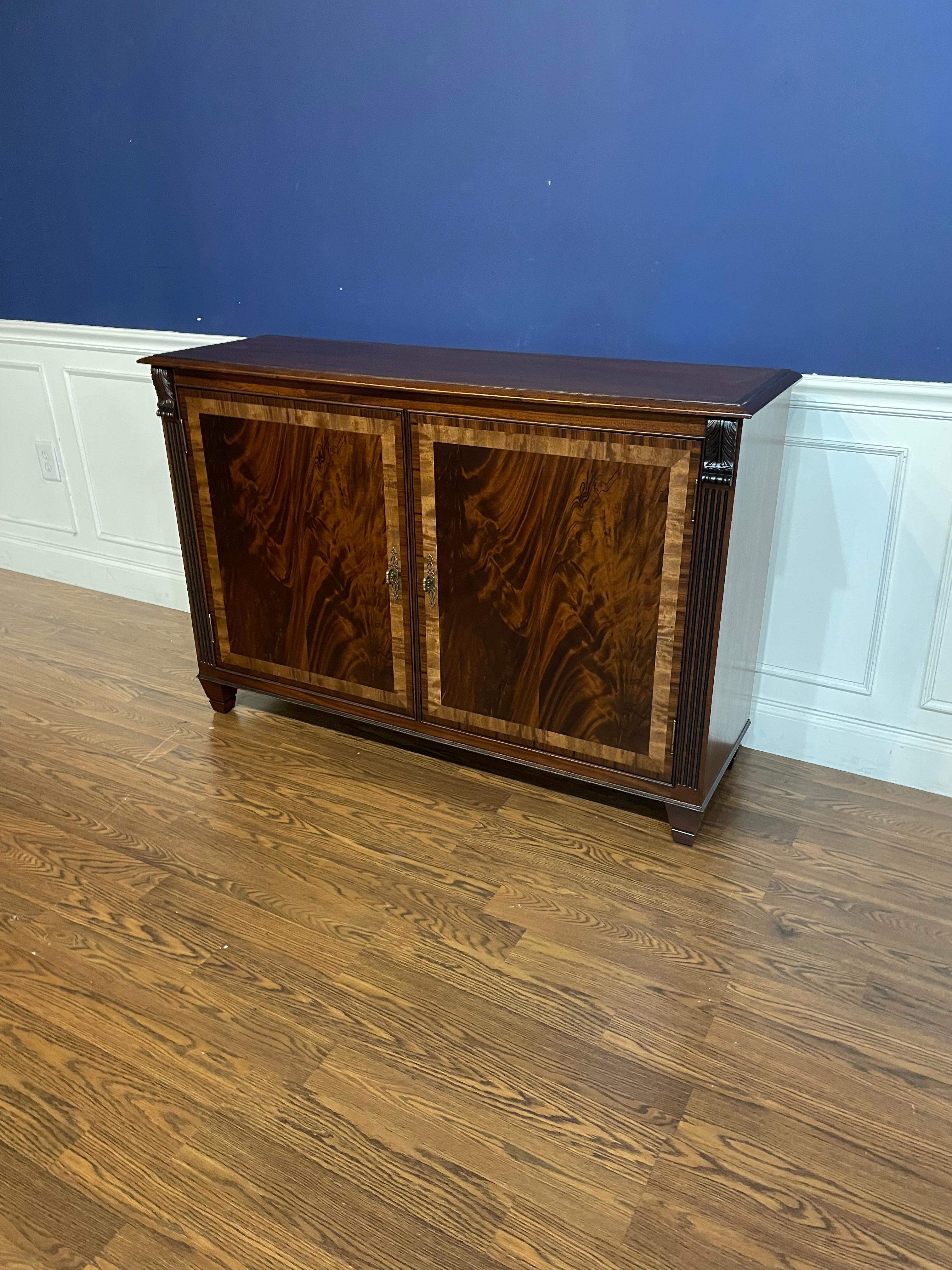 This is made-to-order traditional mahogany two door buffet or credenza made in the Leighton Hall shop. It features two doors with reverse-slip-match swirly crotch mahogany fields and Satinwood and Santos Rosewood (Pau Ferro) borders. It has a