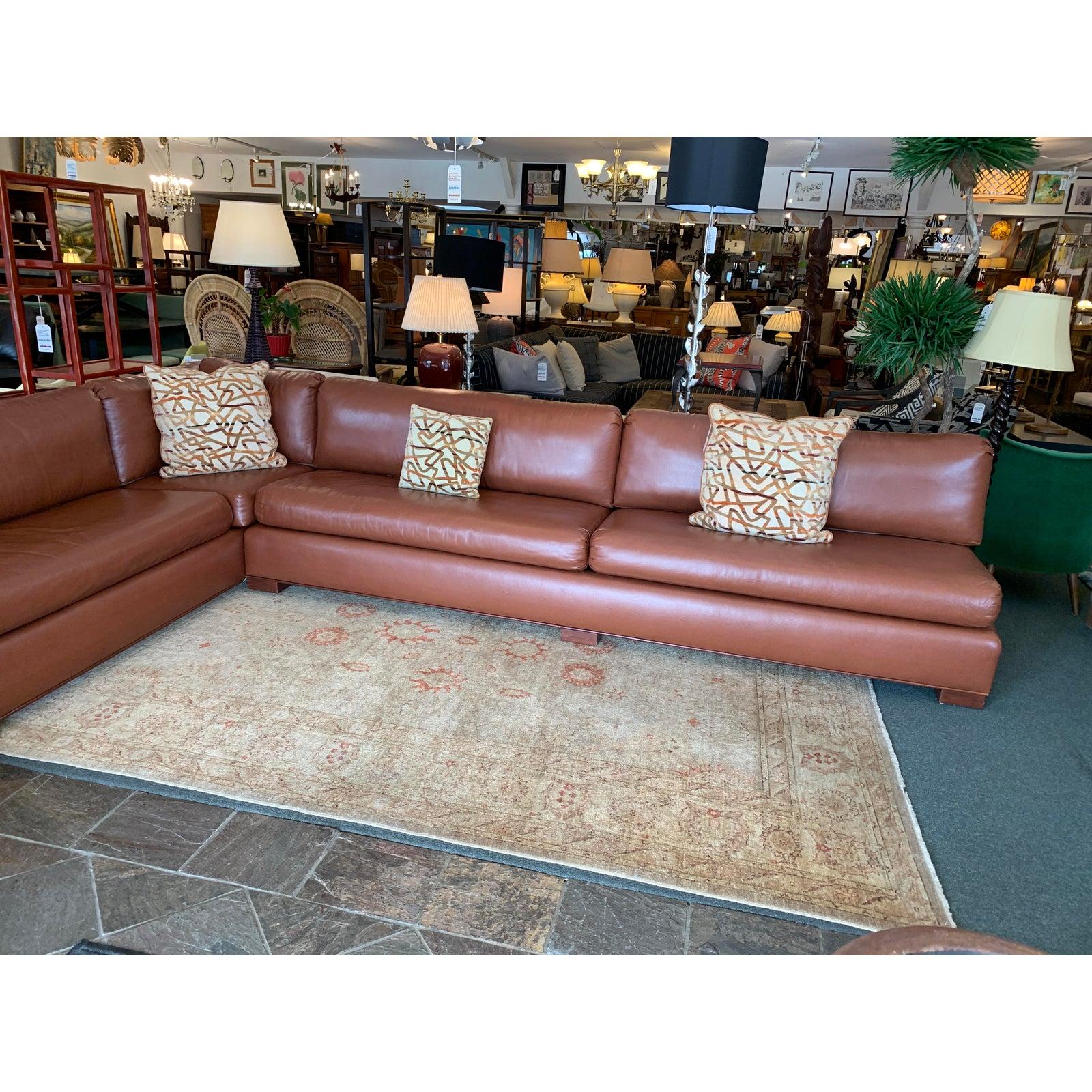 Presents a custom Large two-piece sectional seat. Soft synthetic fill with high density foam give soft yet firm support for hours of lounging. Easy to maintain vinyl has shagreen like texture in richly warm cognac tone. Composed of two large pieces
