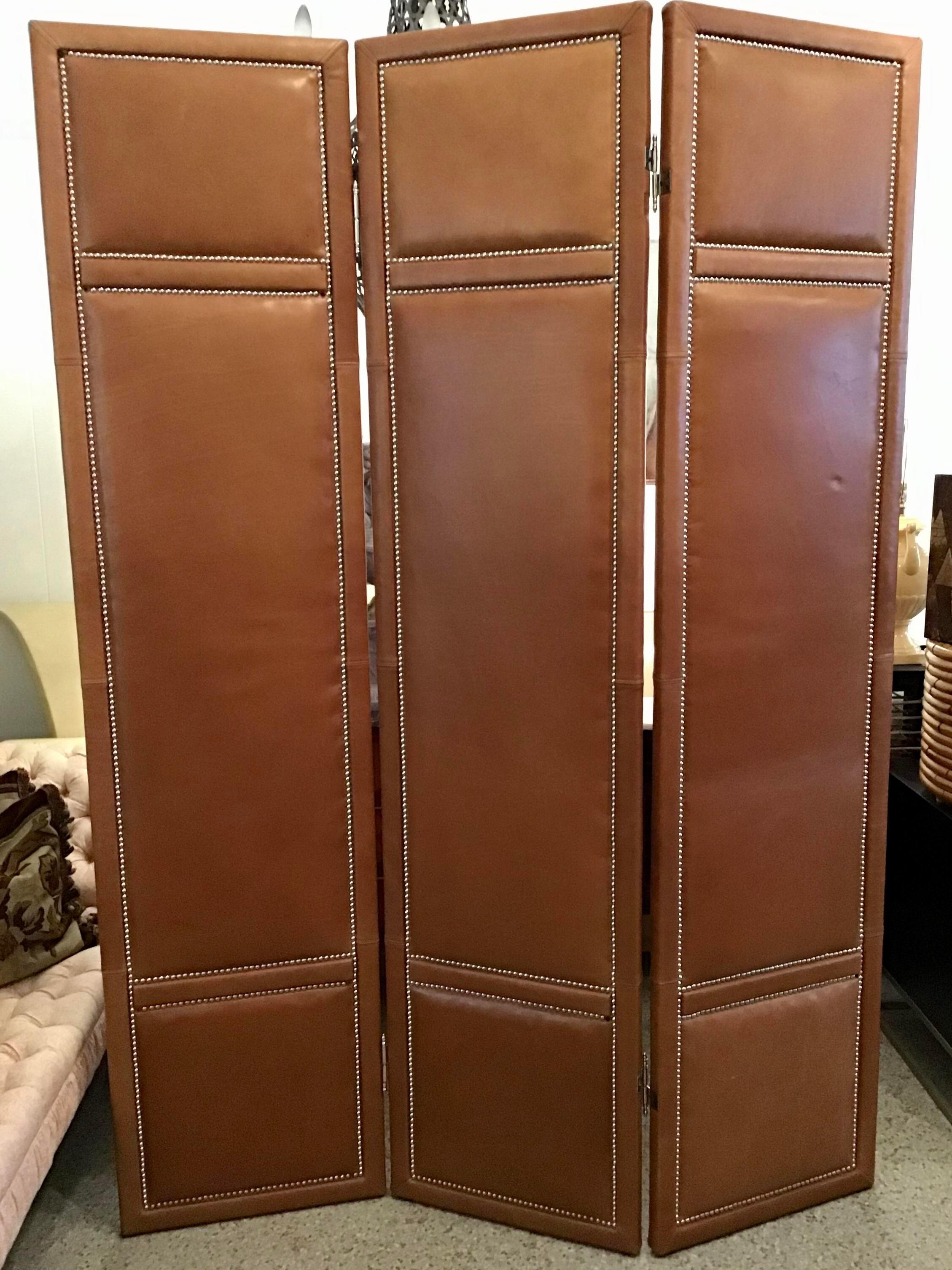 Fabulous 3 Panel custom leather folding screen with Chrome nailheads. This screen is extremely well made with very high quality leather. The screen would work well as a room divider or back drop to beautiful furnishings. 

Additional