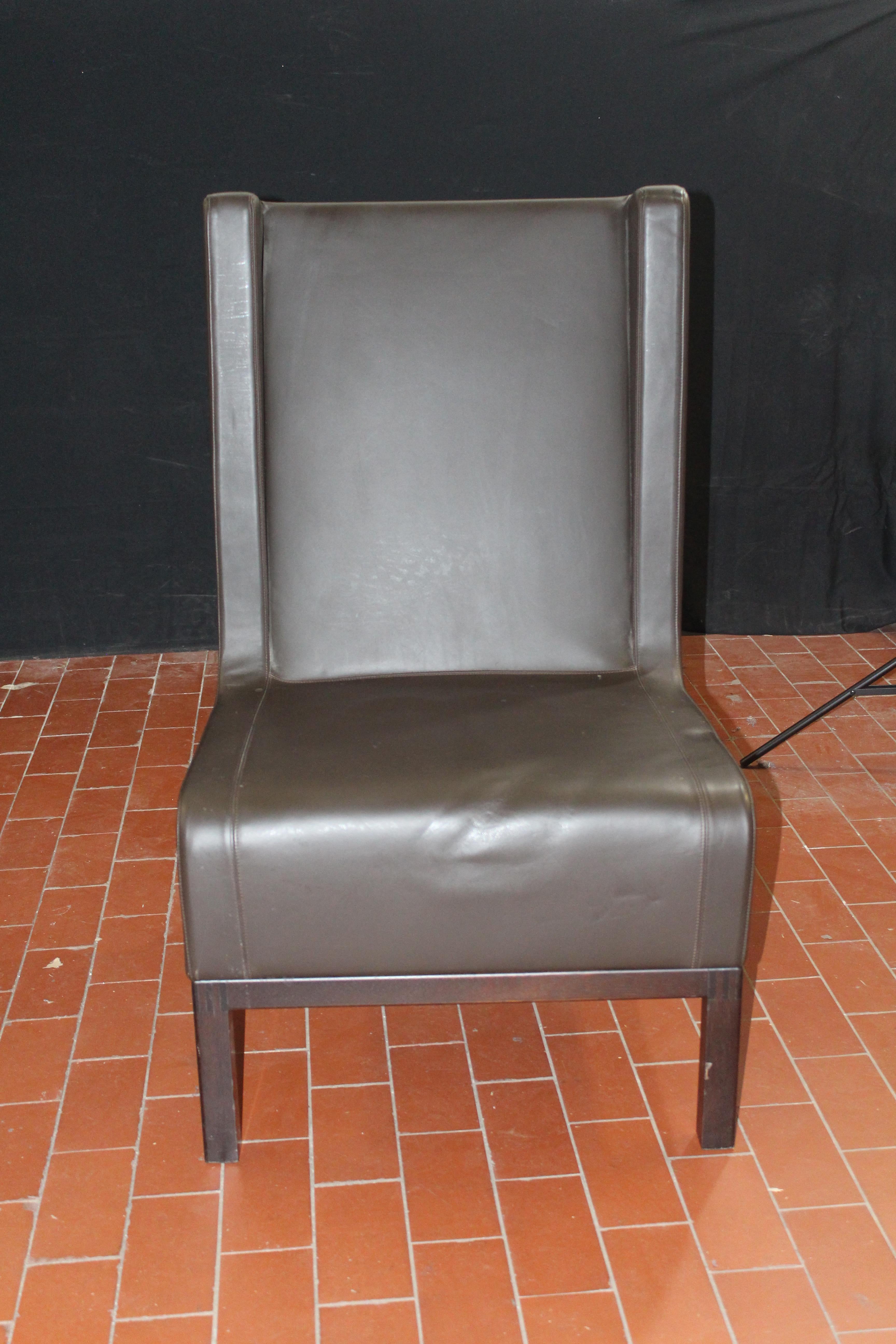 Custom leather side chair in a rich brown leather on matched finished bases.