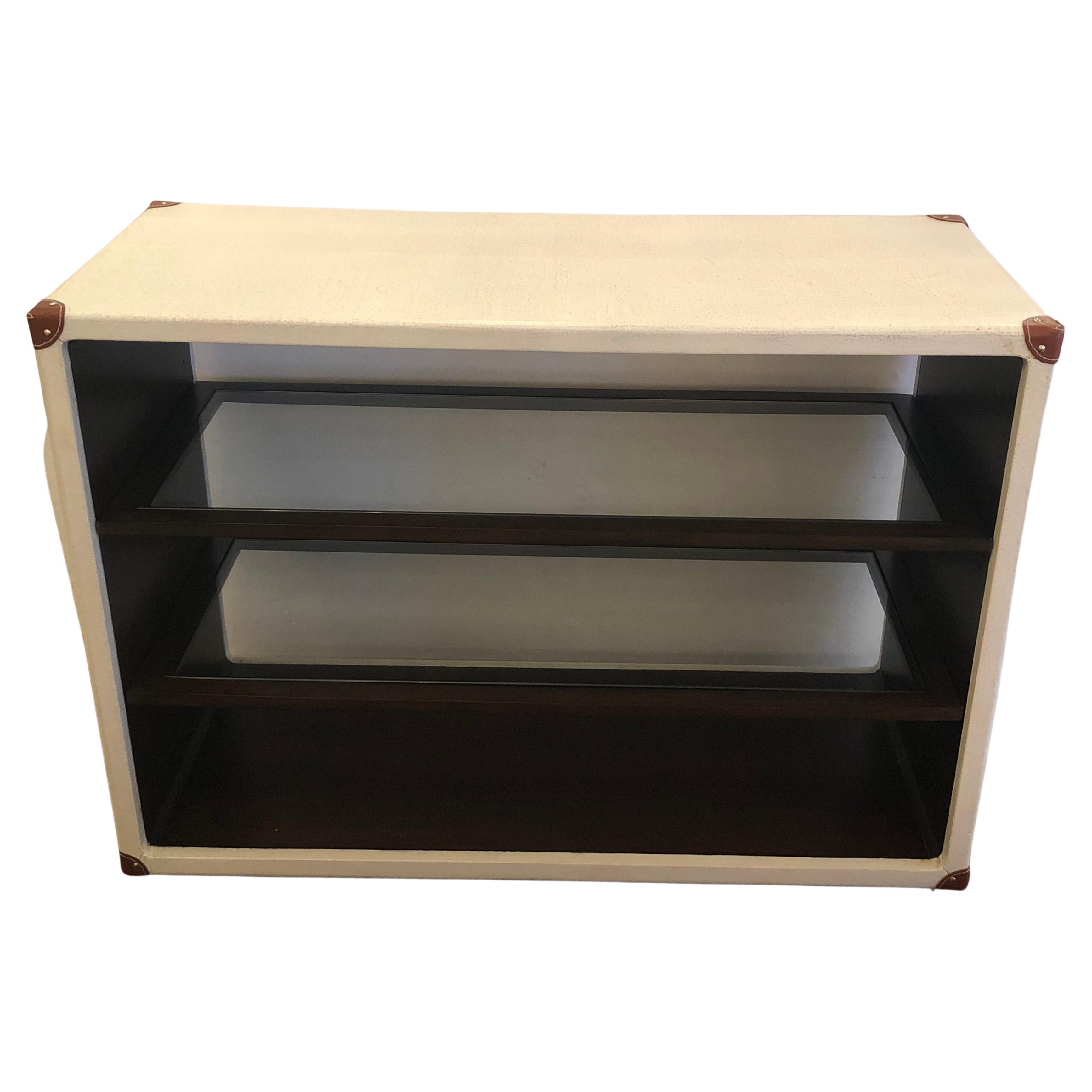 Ultra chic Century Furniture custom console bookshelf having speckled cream and brown faux leather wrapping and handsome brown leather corners.  The inside is mahogany with 3 adjustable glass shelves.  Heavy and substantially made.
8.25-8.5 