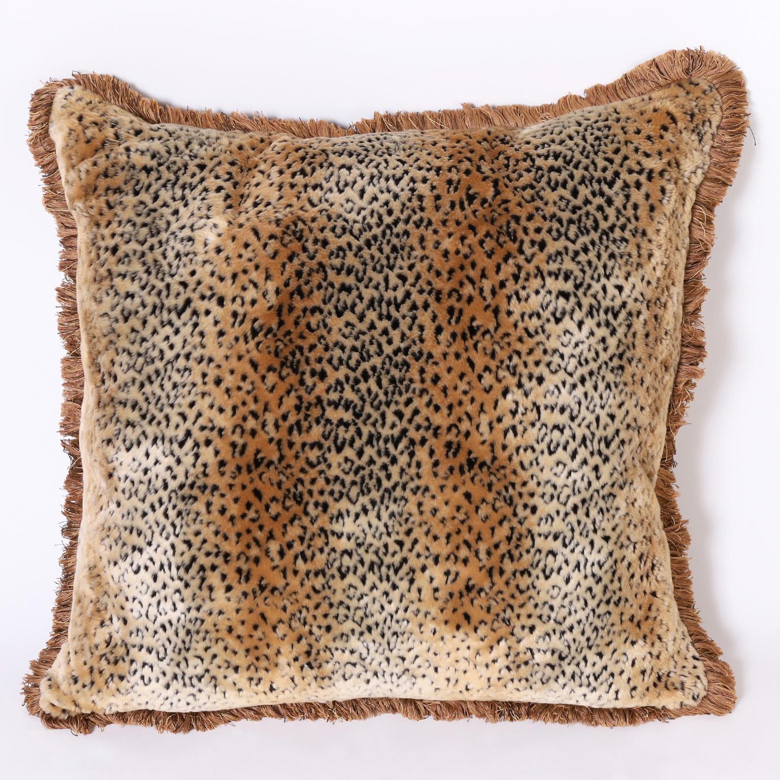 Chic pair of oversize pillows with velveteen leopard print fronts bordered in fringe and with cotton backs. Priced individually.