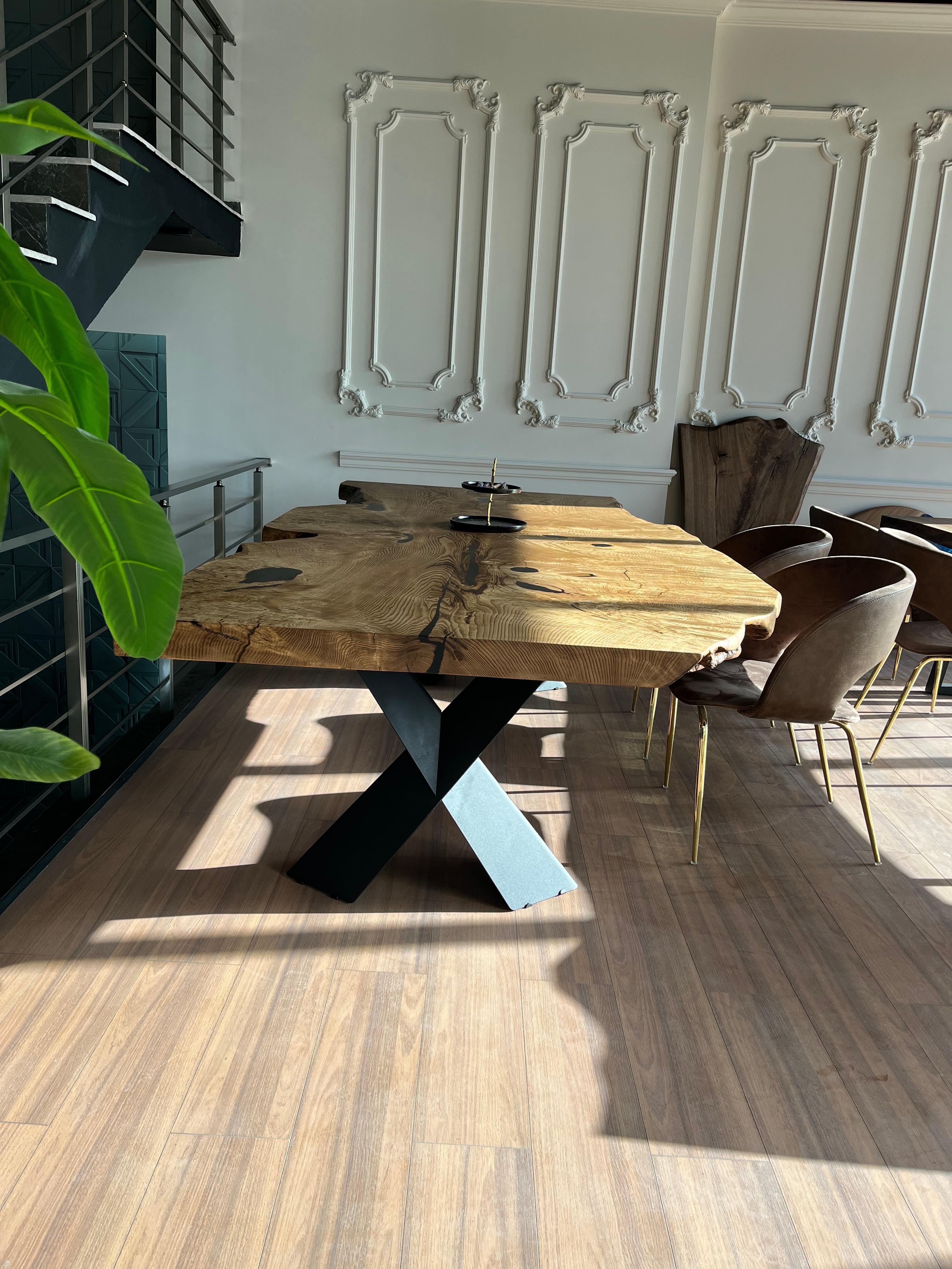 LIVE EDGE ASH WOOD DINING TABLE

This table is made of natural ash slabs. 

Some Ash slabs have a lot of natural beauty as it’s one side has a large curve. This is one of them! 

We've filled the cracks with black epoxy, without disrupting